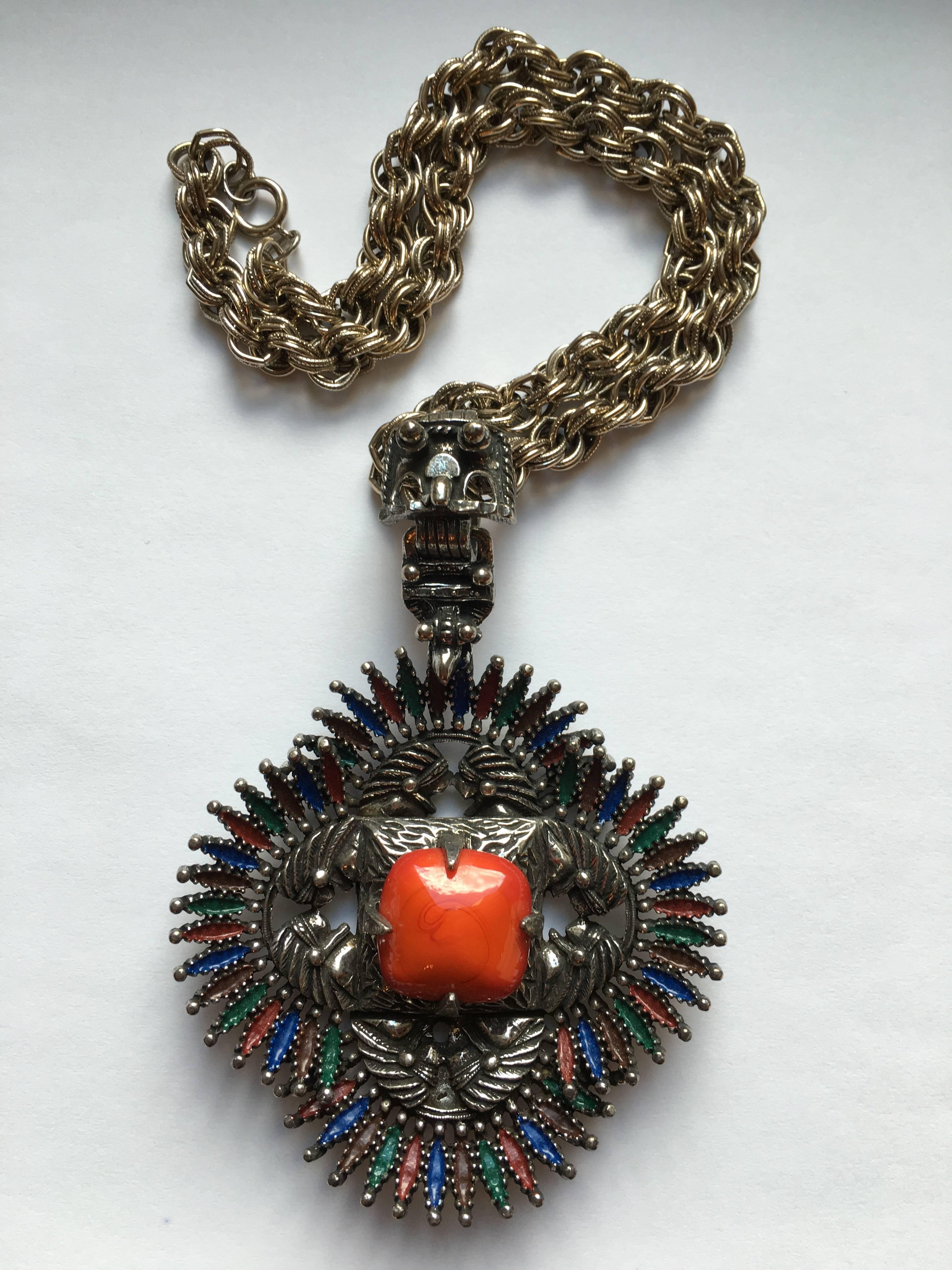 This silvertone pendant necklace was created for Castlecliff in 1973 by the jewelry designer, Larry VRBA. Its pendant is large measuring 3" wide by 4 3/8" long which includes the 1 3/8" long bale. The pendant appears to be an