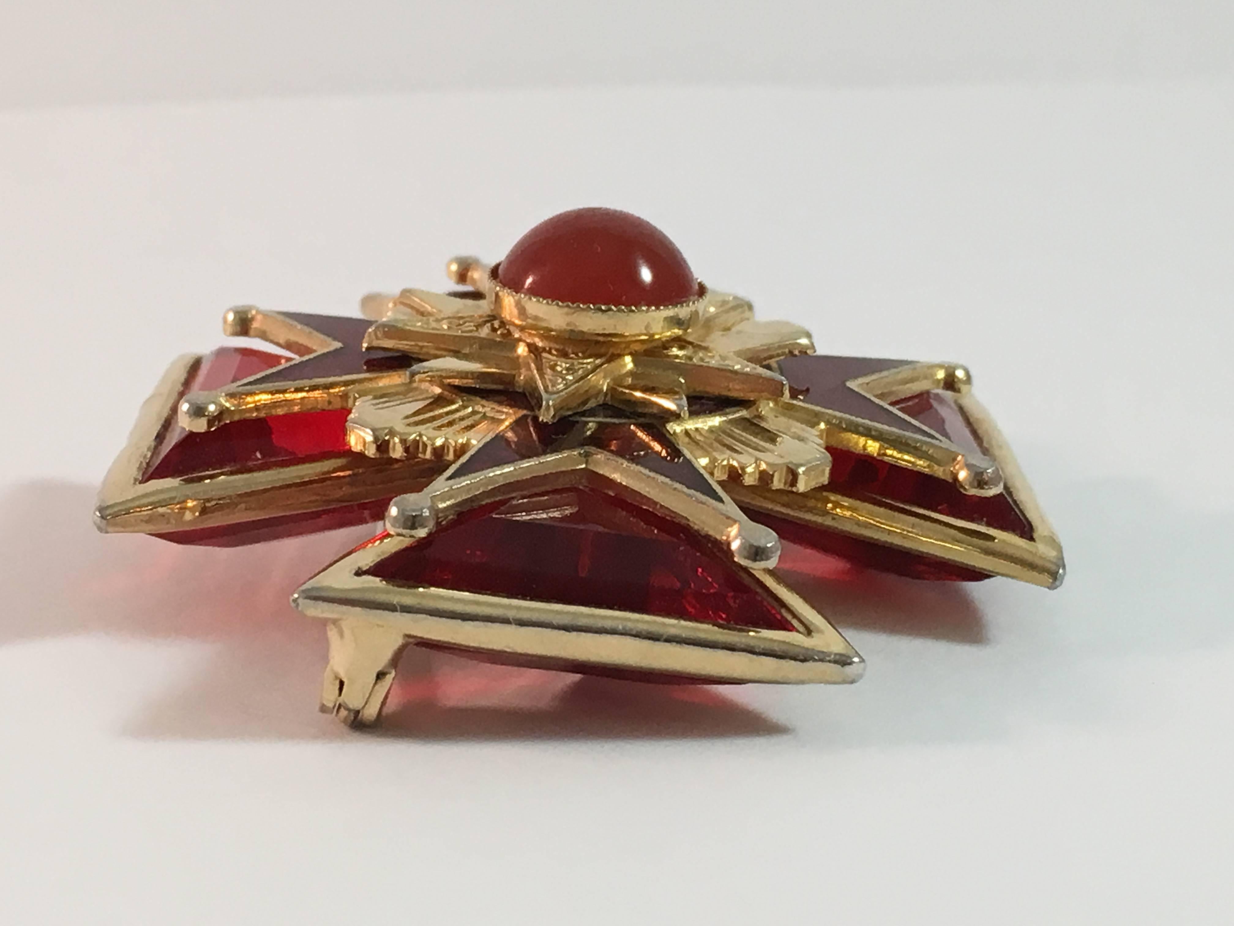 This is a 1960s red glass maltese cross brooch. It is in excellent condition and measures 1 3/4