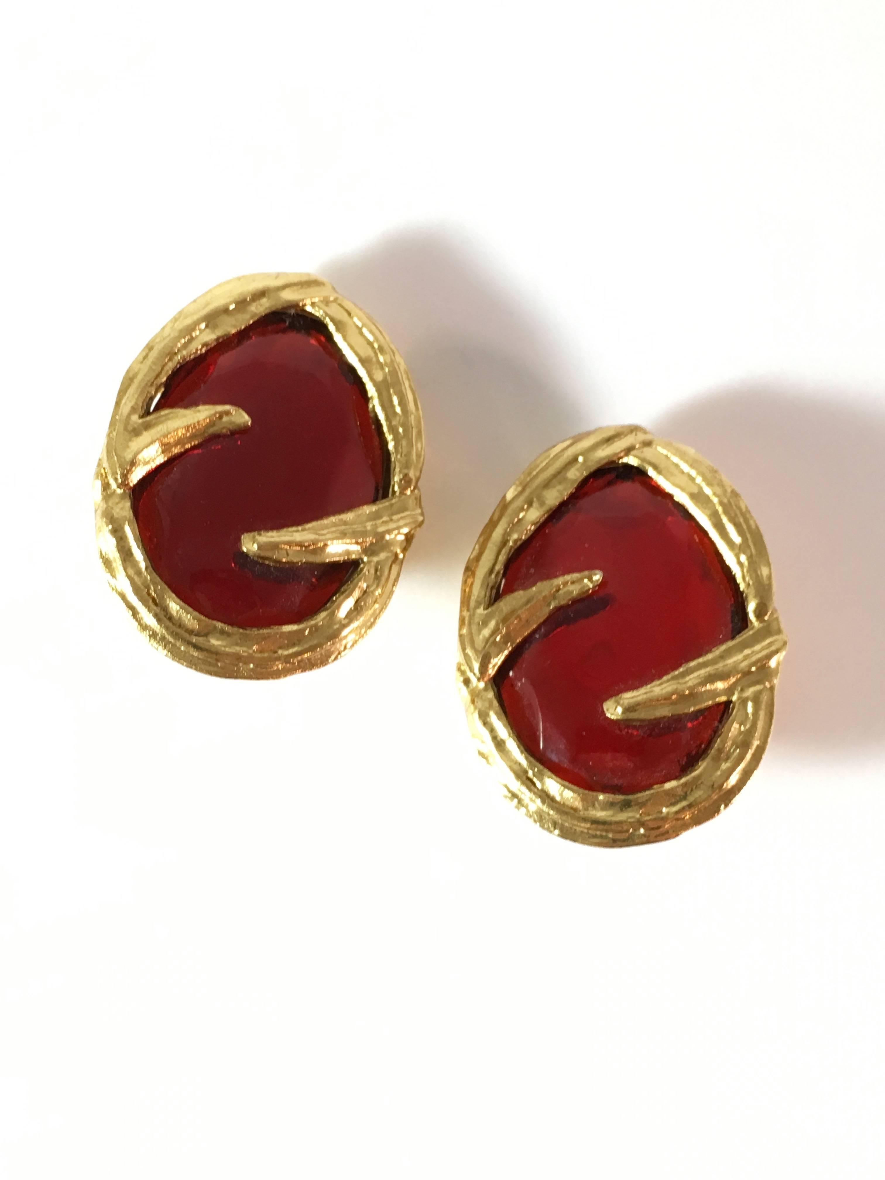 This is a pair of fabulous Yves Saint Laurent clip-on earrings from the 1980s. They are gold-tone and red Gripoix glass earrings. They are signed on the back, 'YSL Made in France' on the back of the earrings and 'YSL' on the back of the clip portion