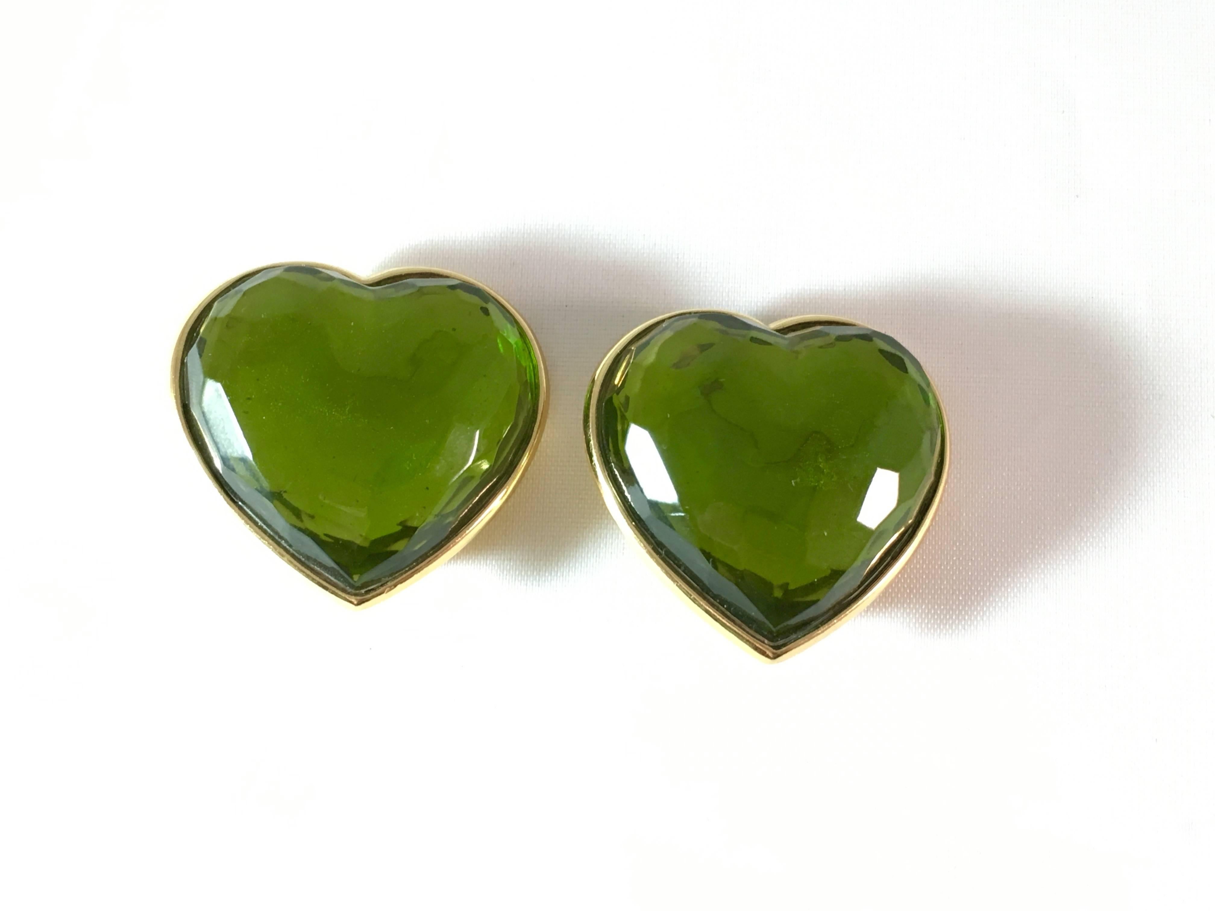 This is a pair of fabulous Yves Saint Laurent green glass heart clip-on earrings from the 1980s. They are signed 'Made in France' on the back of the earrings and 'YSL' on the back of the clips. The clips are strong and the earrings are in excellent