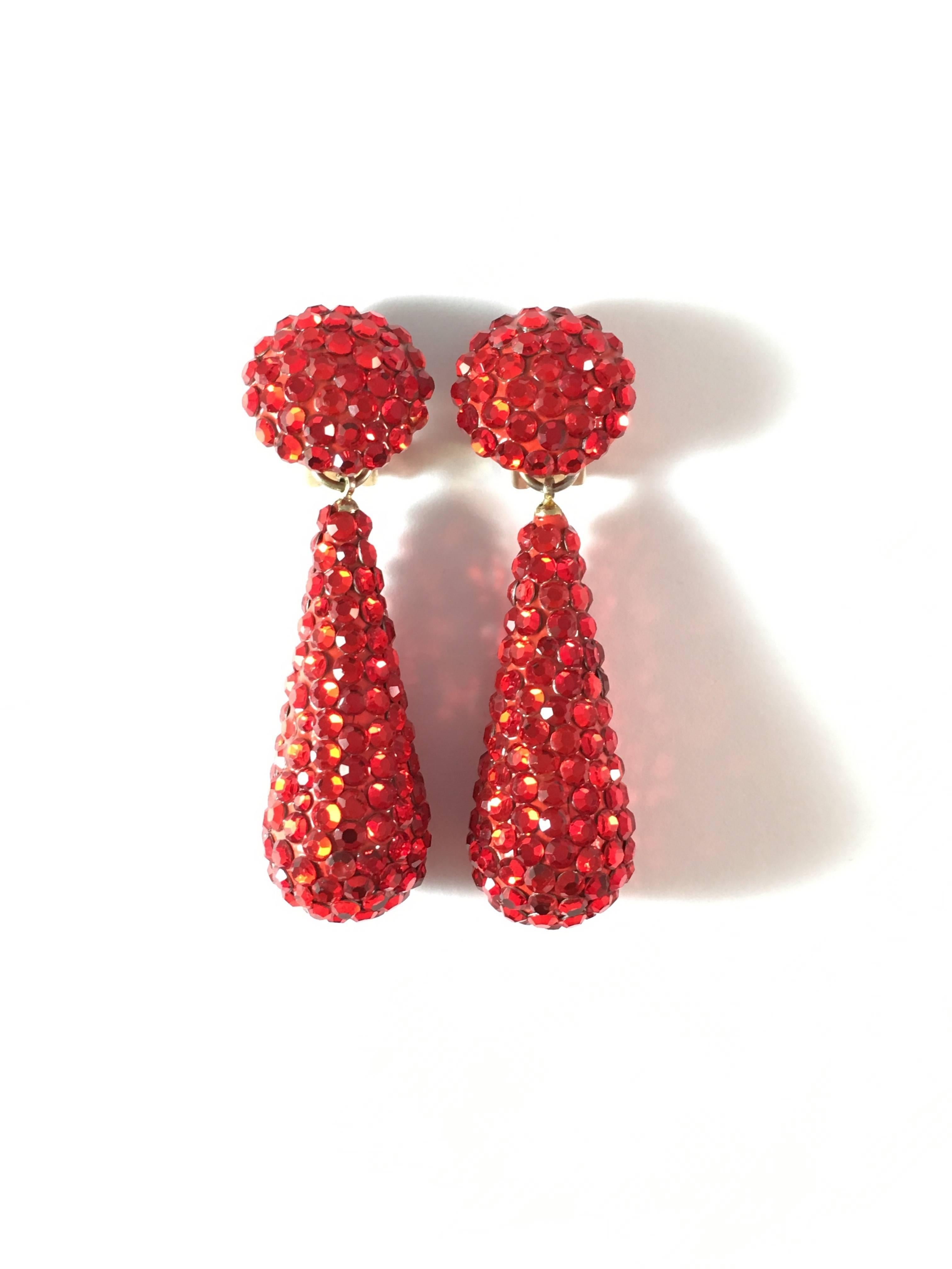 These red dangle clip-on earrings are perfect for the holidays. They were made by Richard Kerr in the 1980s and are made up of his signature pave rhinestones. They are signed 'Richard Kerr' on the back (image #5). They measure 2 1/2