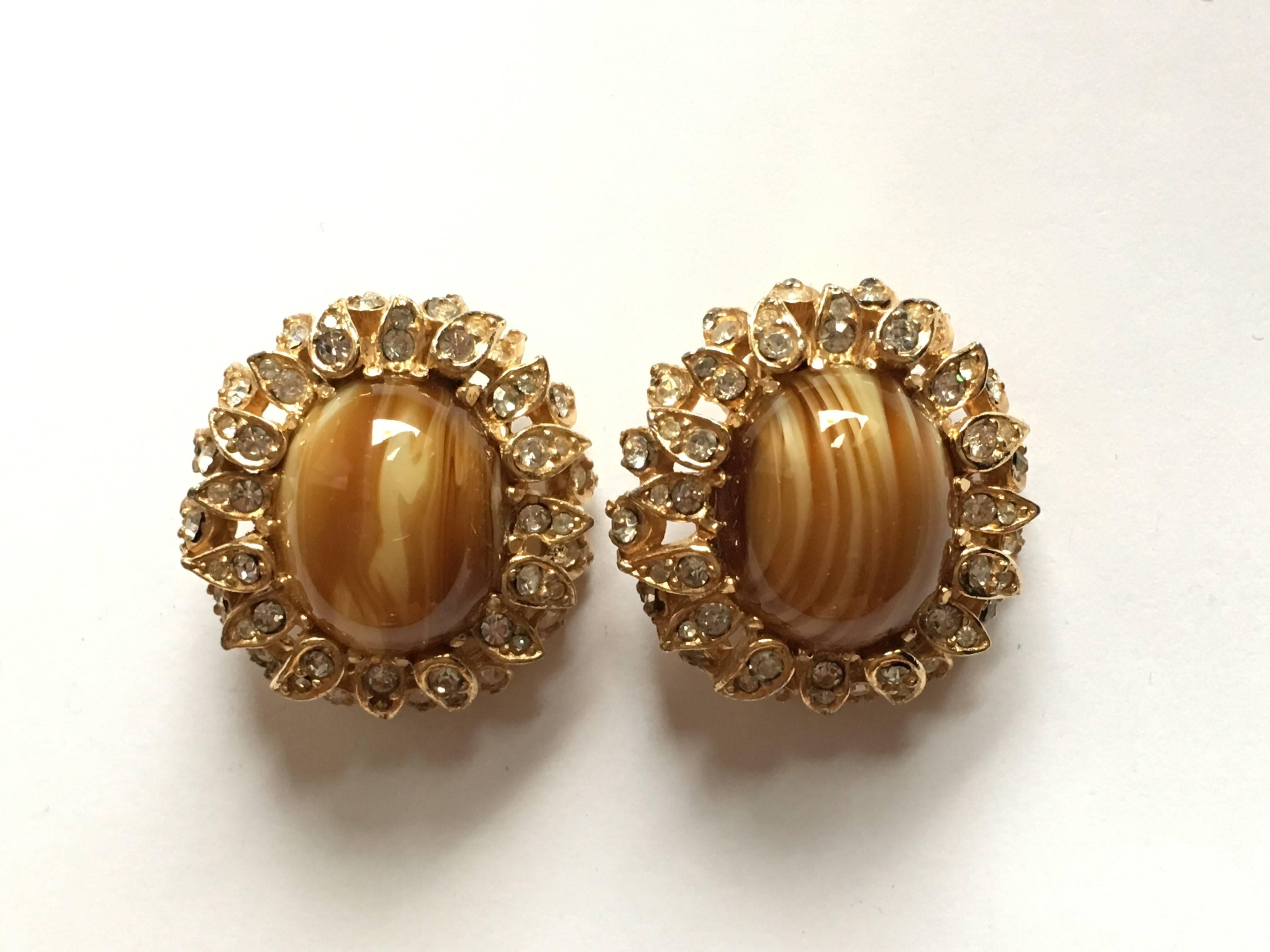 This is a pair of beautiful tiger's eye and clear rhinestone clip-on earrings from Ciner. They are in very good vintage condition and the clips are tight. They measure 1 1/16