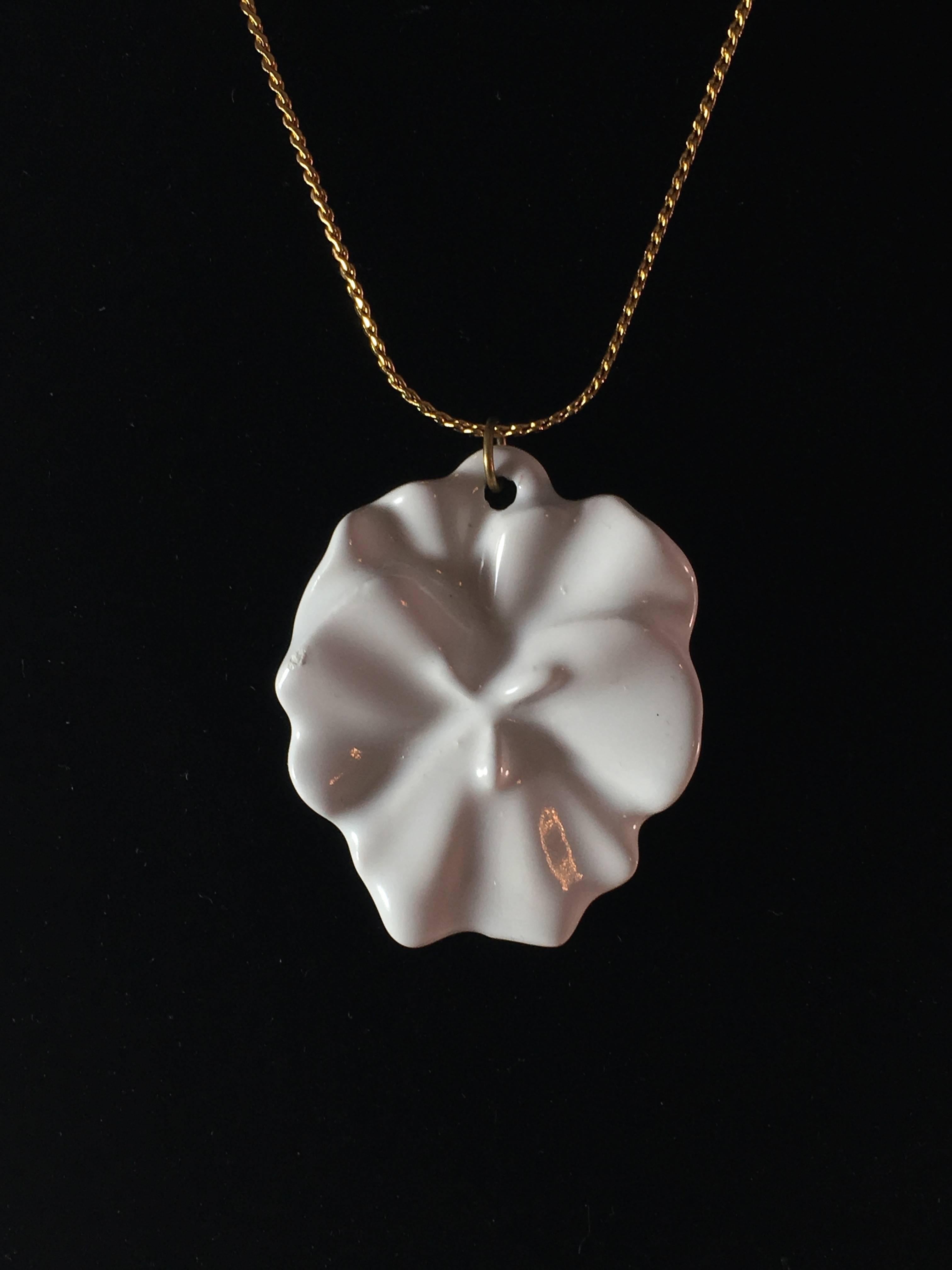 This is a unique 1970s white porcelain pendant flower necklace designed by Kenneth Jay Lane for Adrian. It is not marked on the necklace but has its original hang tag which says, 'Adrian brings you something by Kenneth Jay Lane'. The pendant is