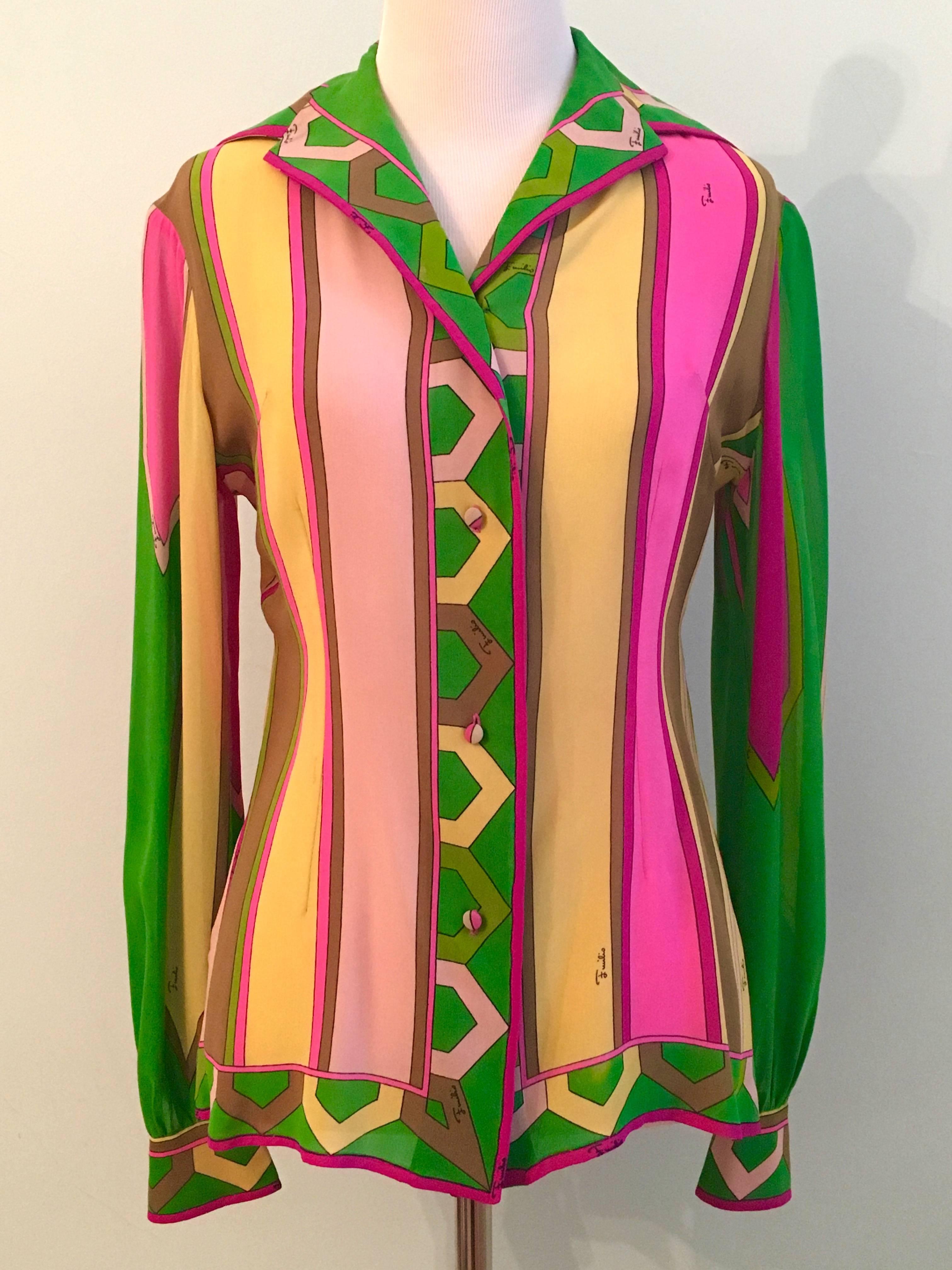 This is an amazing Emilio Pucci blouse from the 1960s. It is silk chiffon and printed with a brightly colored abstract stripe design. It is signed 'Emilio Pucci' throughout the print. It is in very good vintage condition with the exception of a few
