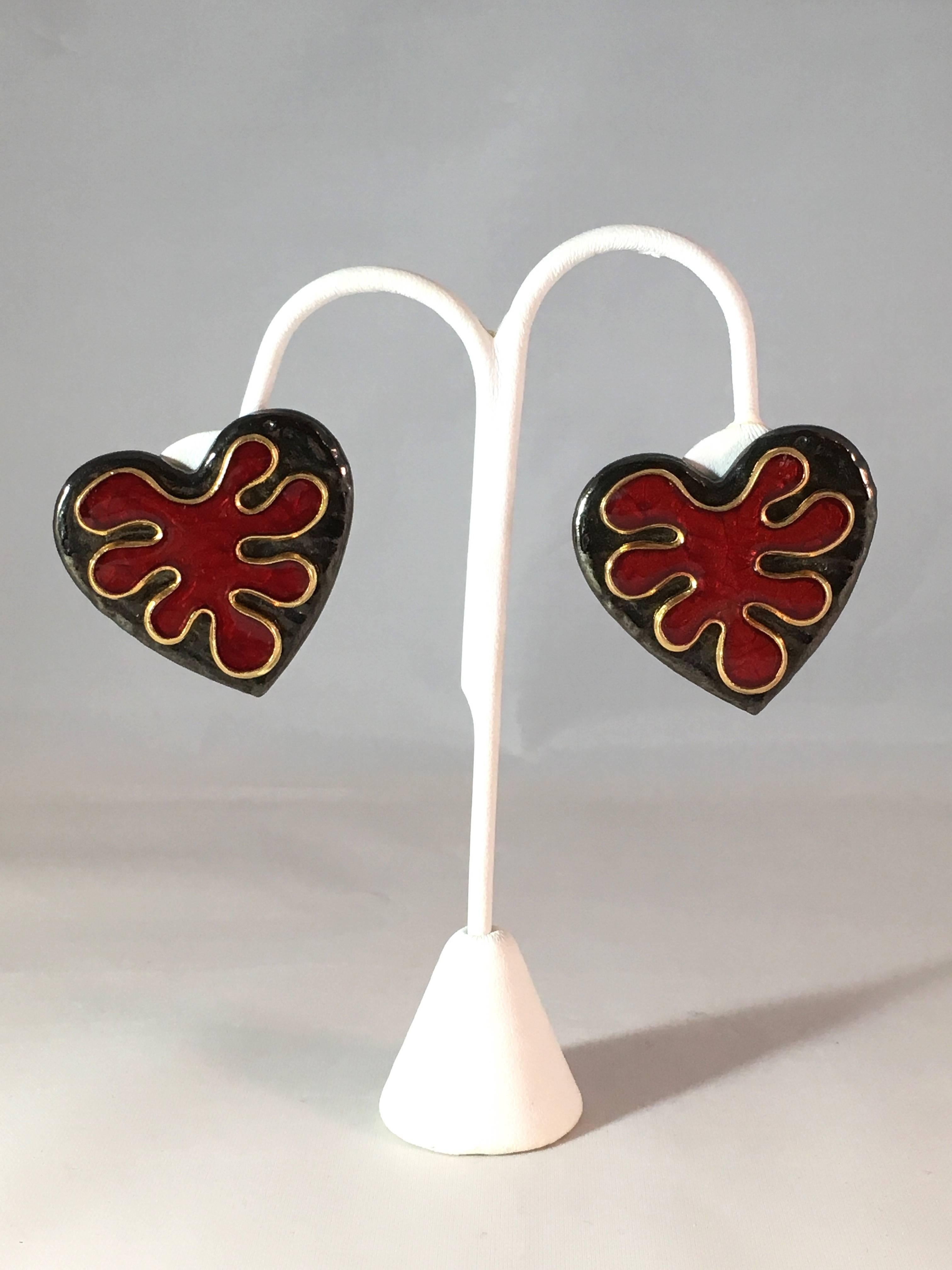 This is a pair of fabulous Yves Saint Laurent black and red heart clip-on earrings from the 1980s. The red portion in the center of the hearts look like Matisse cut-outs. The earrings are signed 'YSL' on the back of the clips and marked 'YSL' on the
