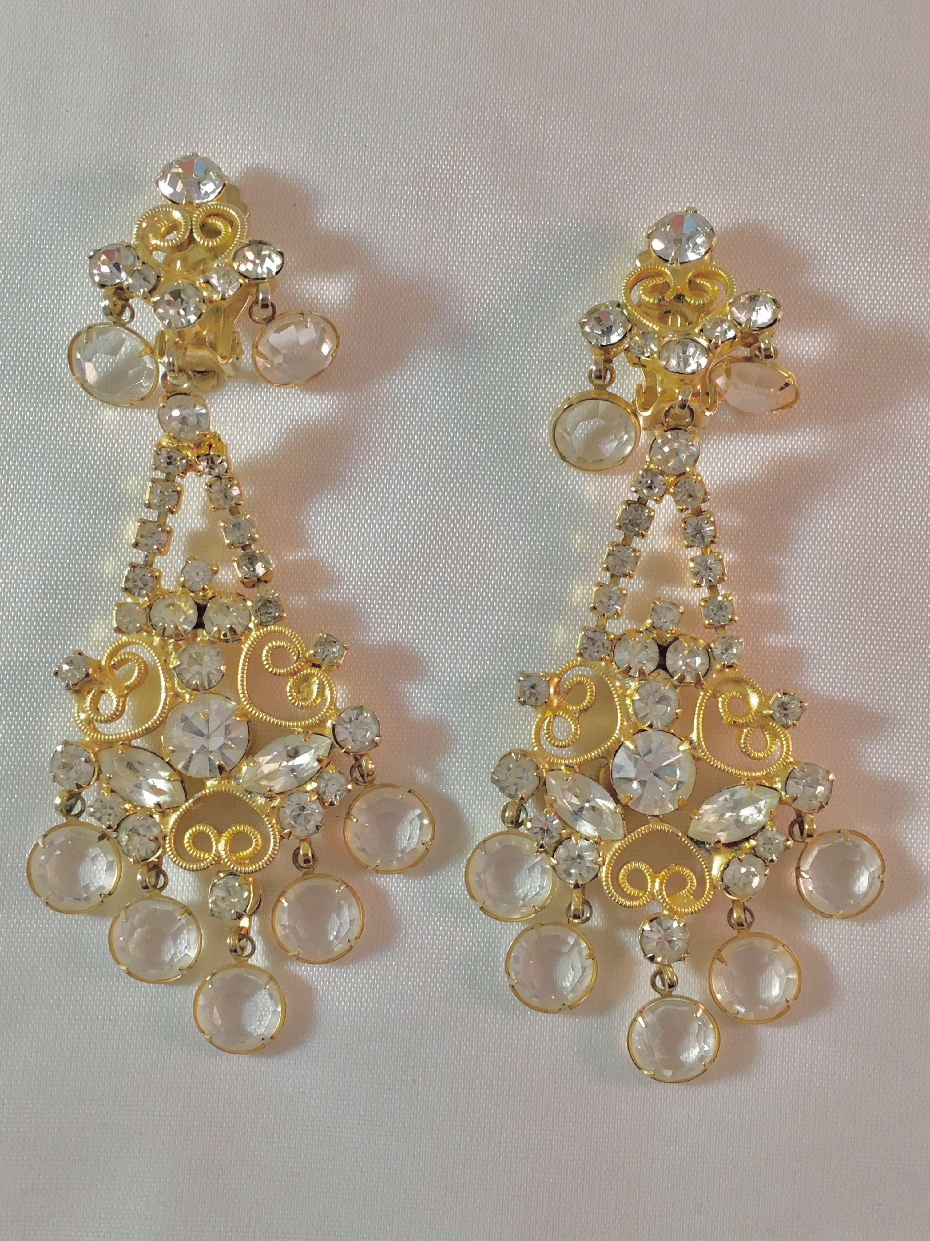 These showstoppers are an amazing example of Kenneth Jay Lane at his 1960s peak. They are chandelier clip-on earrings made up of clear rhinestones set in goldtone metal. They measure 3 1/2" long x 1 3/4" wide and are marked 'K.J.L.' on the