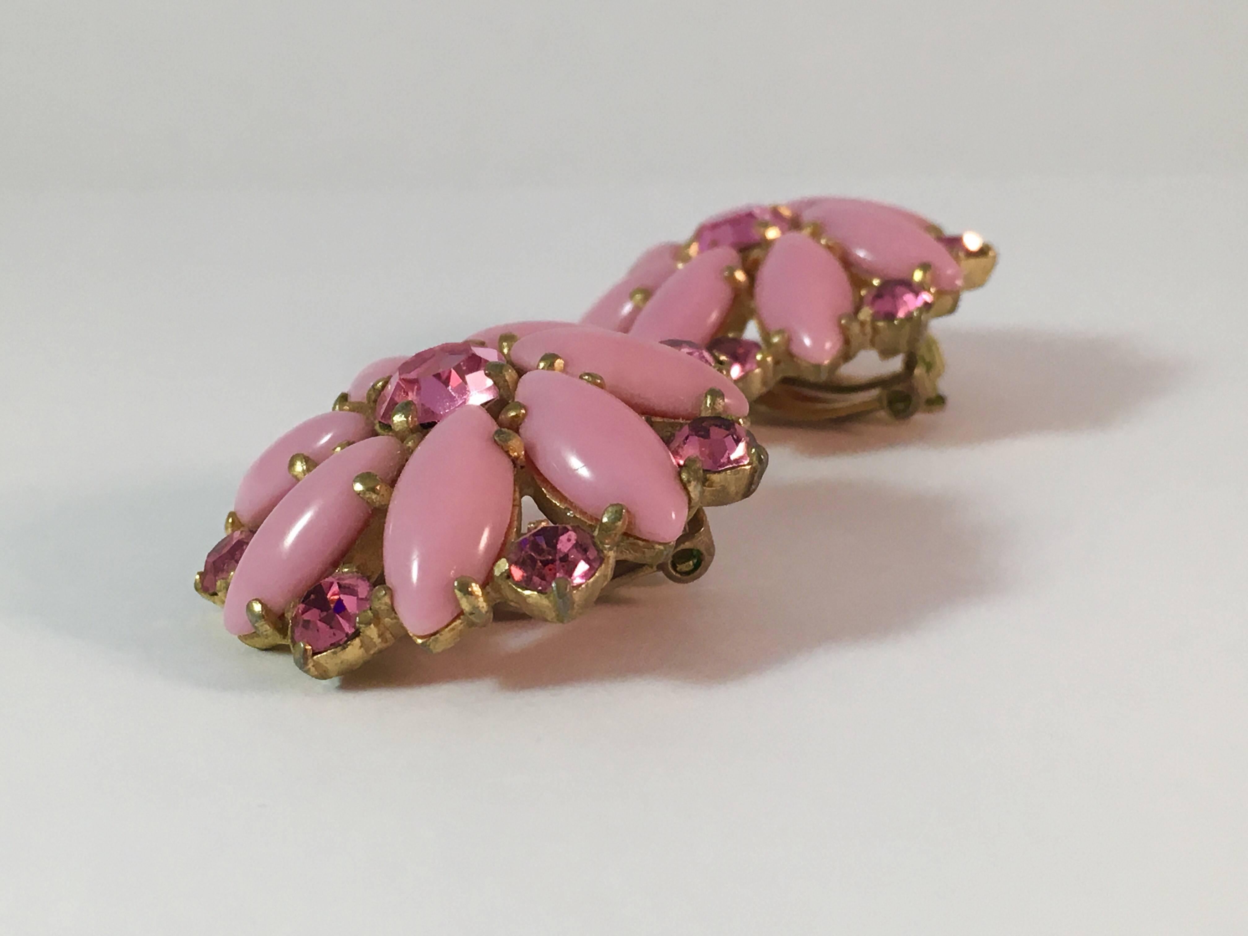 This is a pair of classic Elsa Schiaparelli earrings in her signature color - pink. They are beautifully made up of opaque glass beads and clear pink rhinestones. There is some wear to the goldtone finish on the backs of the earrings but not to the