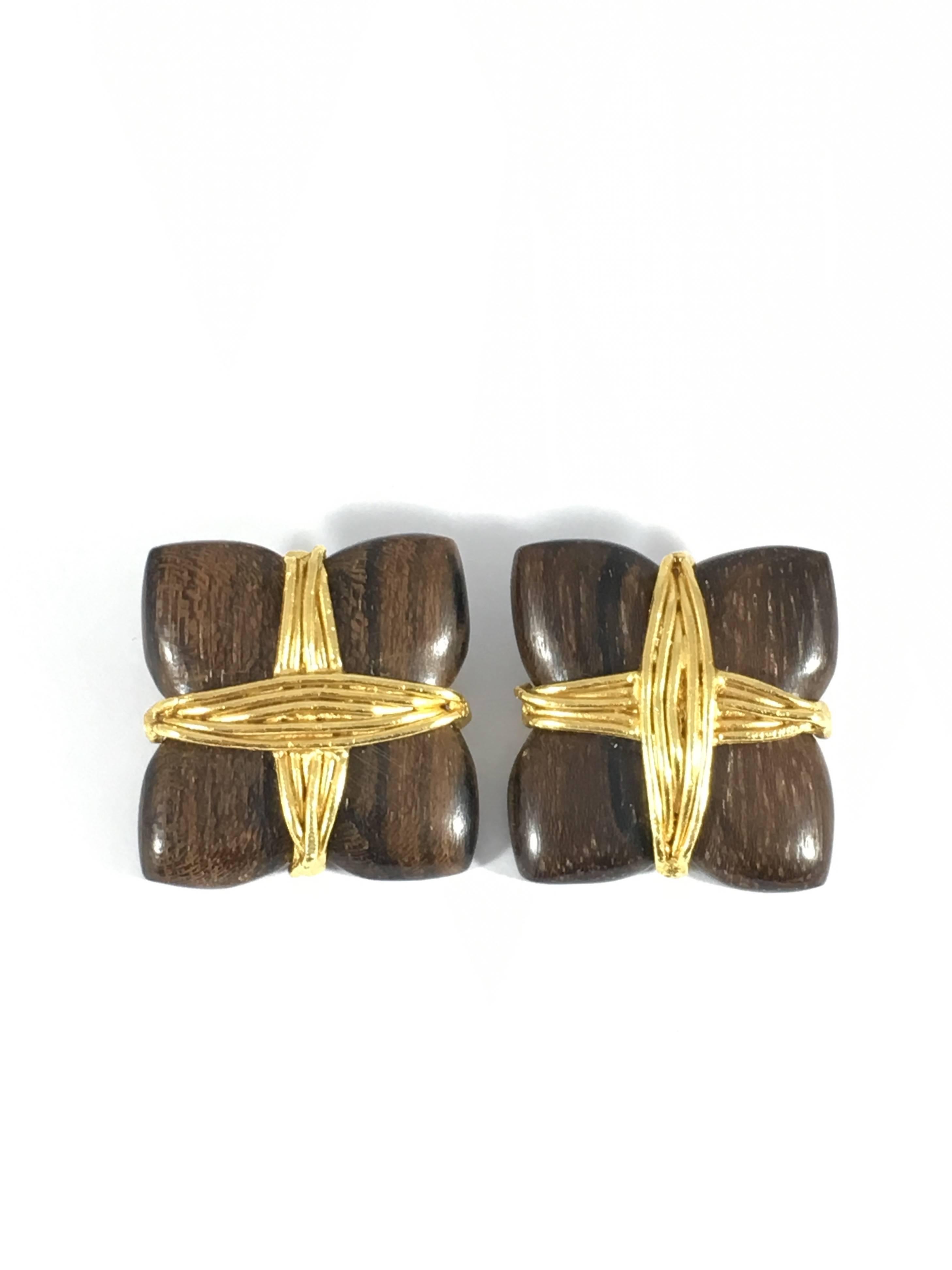 These are wooden Yves Saint Laurent Rive Gauche clip-on earrings from the 1980s. Rive Gauche was Yves Saint Laurent's high end line and the jewelry made for it is beautifully crafted. The earrings measure 1 1/4 inches by 1 1/4 inches. They are