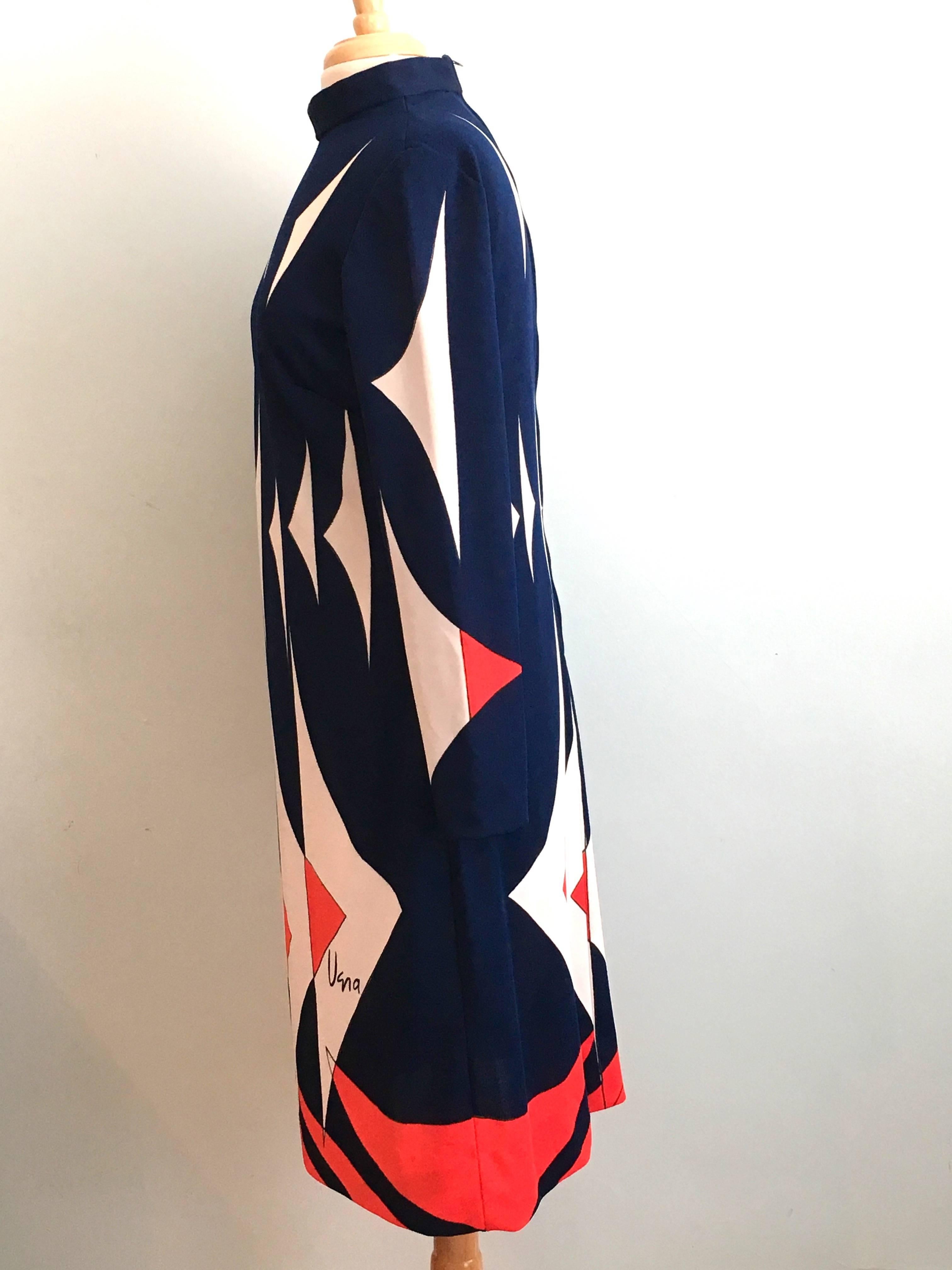 This is a fabulous 1970s graphic print dress from Vera Neumann. It features an abstract red, white and blue print. It is marked 'Vera' in the print on the front of the dress. The label is marked a size 16 but this is vintage sizing. It is more like