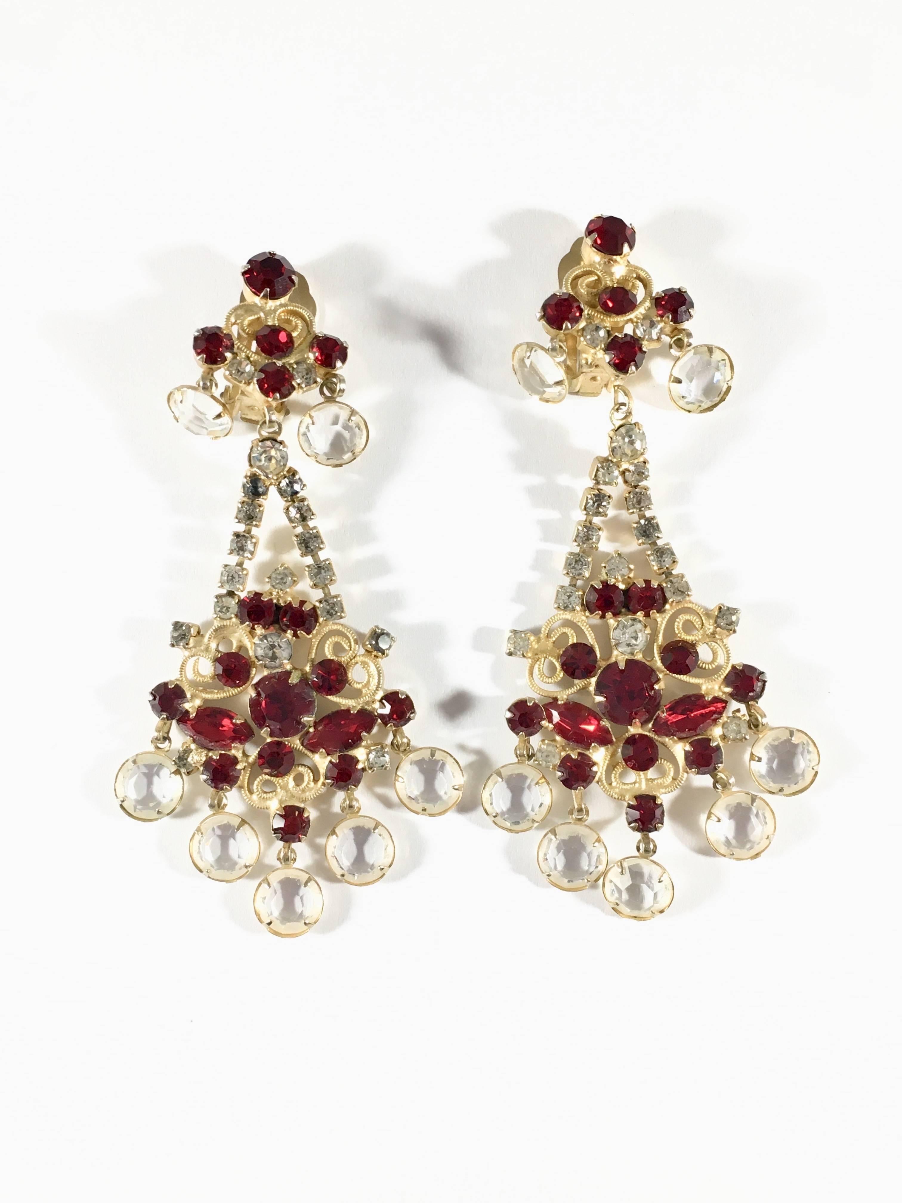 This is a beautiful pair of 1960s Kenneth Jay Lane clip-on chandelier earrings made out of clear and red glass crystal stones. They are 3 3/4 inches long x 1 3/4 inches wide. They are marked 'K.J.L.' on the backs of the earrings - the earliest mark