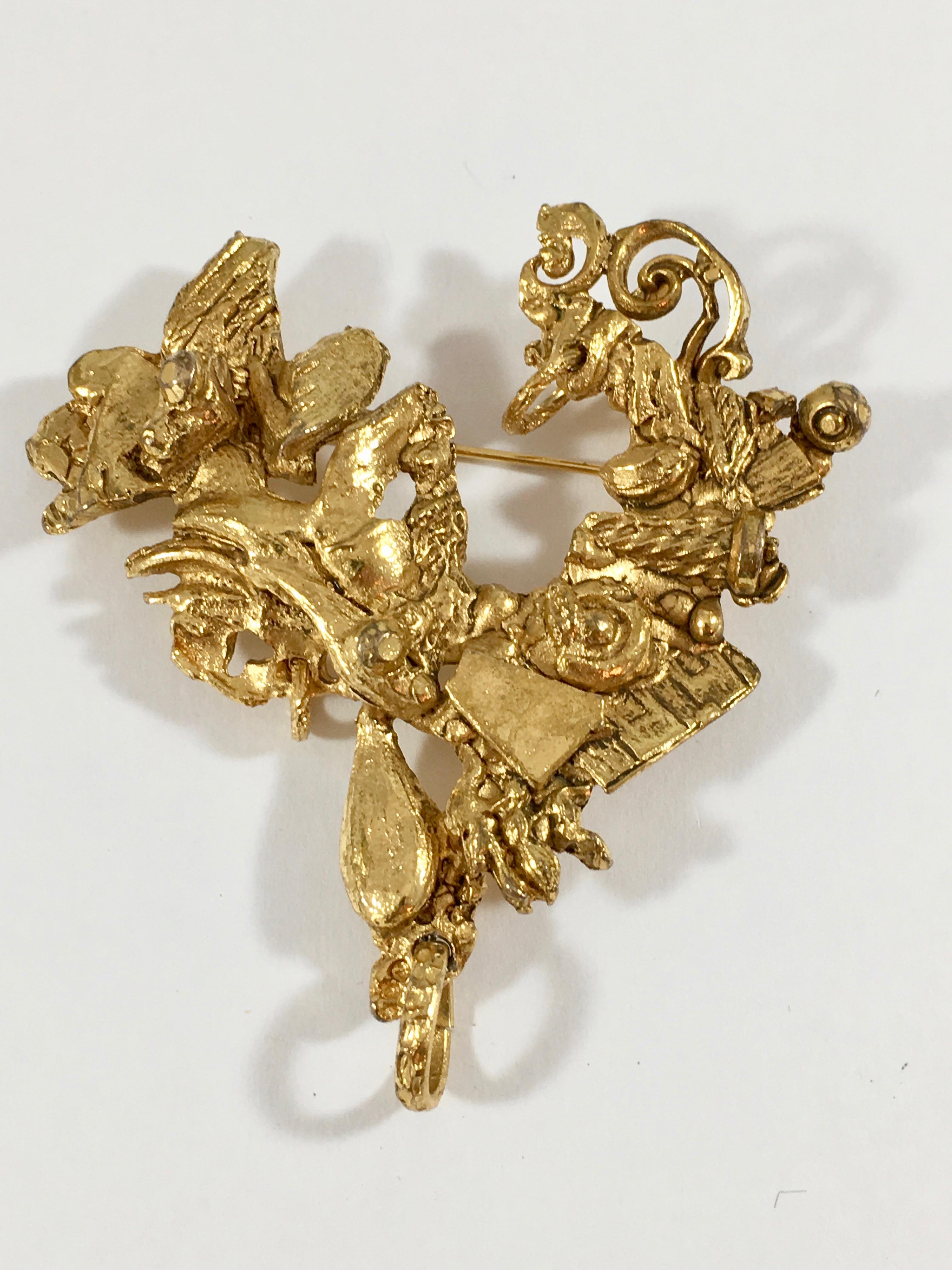 This is a goldtone abstract Christian LaCroix heart brooch from the 1990s.  It measures 3 inches long x 2 3/4 inches wide and is marked 'Christian LaCroix Made in France' on the back of the brooch. It is in excellent condition.
