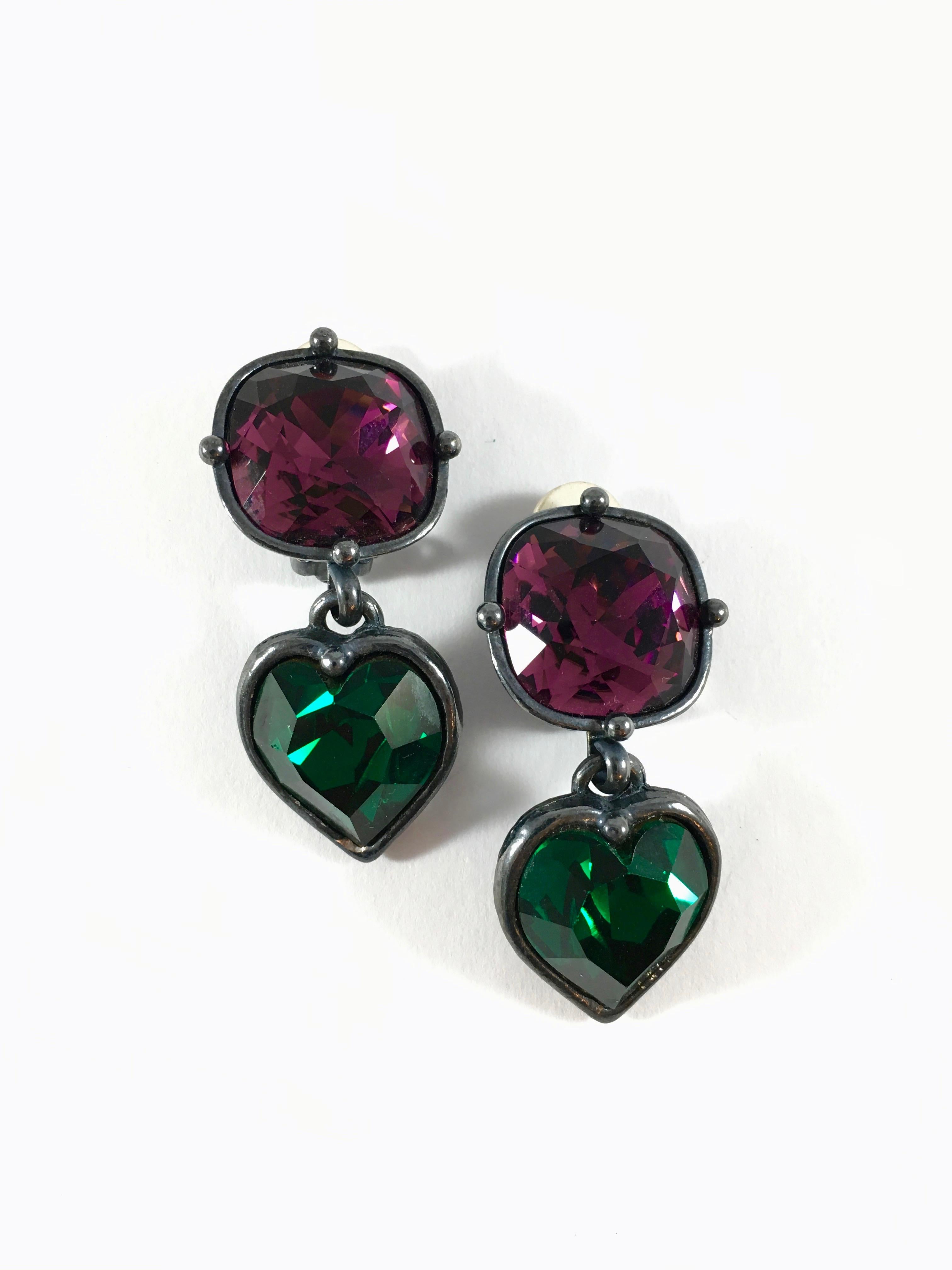 Spectacular Yves Saint Laurent Rive Gauche earrings from the 1980s. They have a charcoal gray gunmetal finish and each earring has a faceted purple square shaped stone with a green faceted heart shaped stone hanging from it. They measure 2 inches