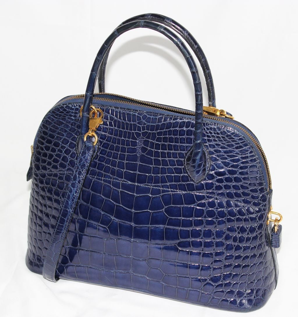 Exceptional Sapphire blue alligator leather Hermès Bolide Handbag of 1995, gold hardware finishing. Letter Y in a circle. 
So actual ! Currently in the Hermès Venizia Window shop (see picture). Highly collectable. Marked Hermès Made in France.