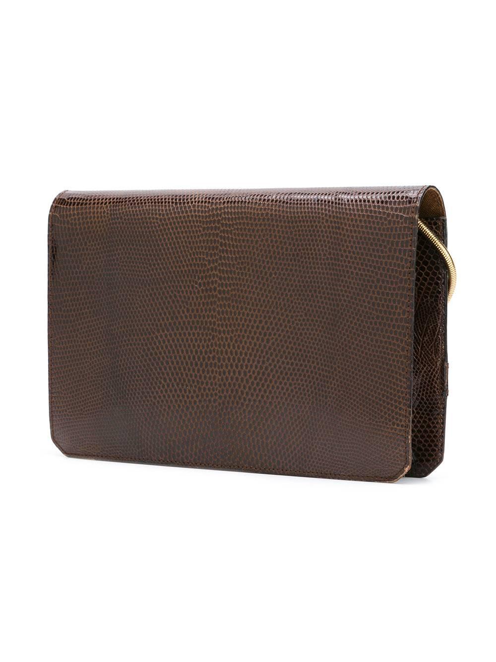 The french chic and elegance with this clutch/bag of the 70s made by Christian Dior. Brown lizard, gold hardware finishing. Snake shoulder strap. 
Marked: Christian Dior Paris
Size: 26 x 17 x 5 cm - 10 1/4 x 6.7 x 2 in. 
Excellent condition. 