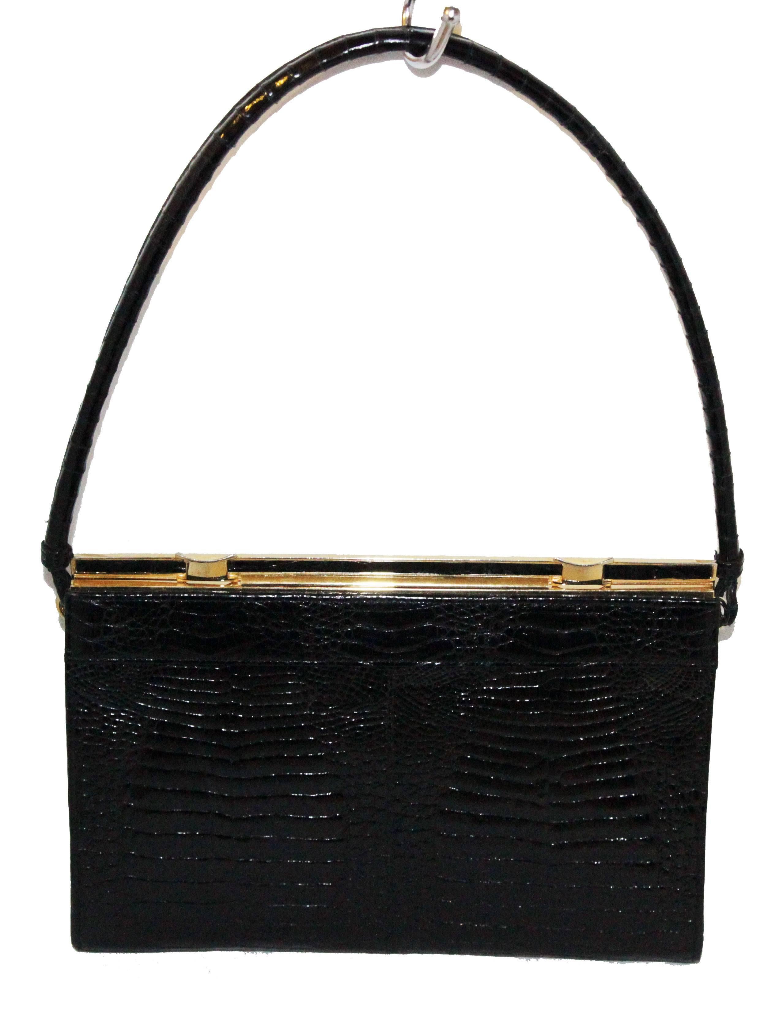 Made of black baby crocodile leather skin, gold metal hardware. Black calf leather lining. Divine quality! Early 70s

Size: 24 x 16.7 x 4 cm - 9.5 x 6.6 x 1.6 in. 

Marked: CIRV certification of crocodile, Assma Creation 

Excellent condition