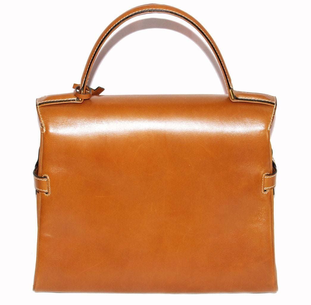 Gorgeous Delvaux Tempête cognac handbag with gold hardware finishing. Excellent condition. One of Delvaux's most architectural and soughafter bags! Size: 28 x 25 x 11 cm.