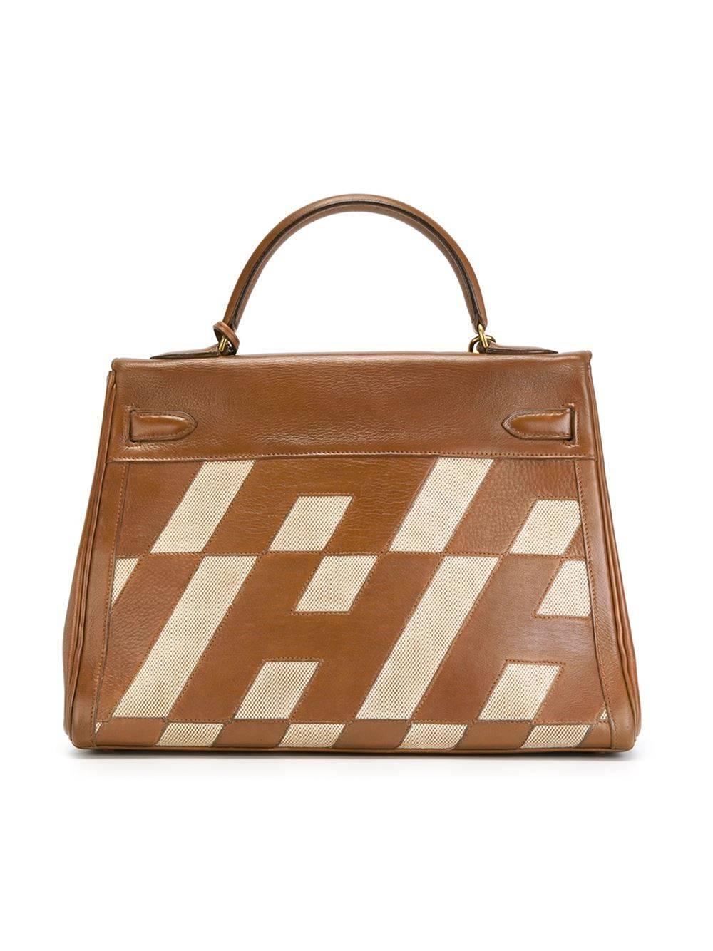 Fabulous Hermès Kelly Handbag, a real collector piece, the Kelly from the Ulysse Collection, year 1970. Cognac brown leather and beige canvas, H pattern. Gold hardware finishing. Excellent vintage condition. Size: 32 cm. 
Just unique, just for