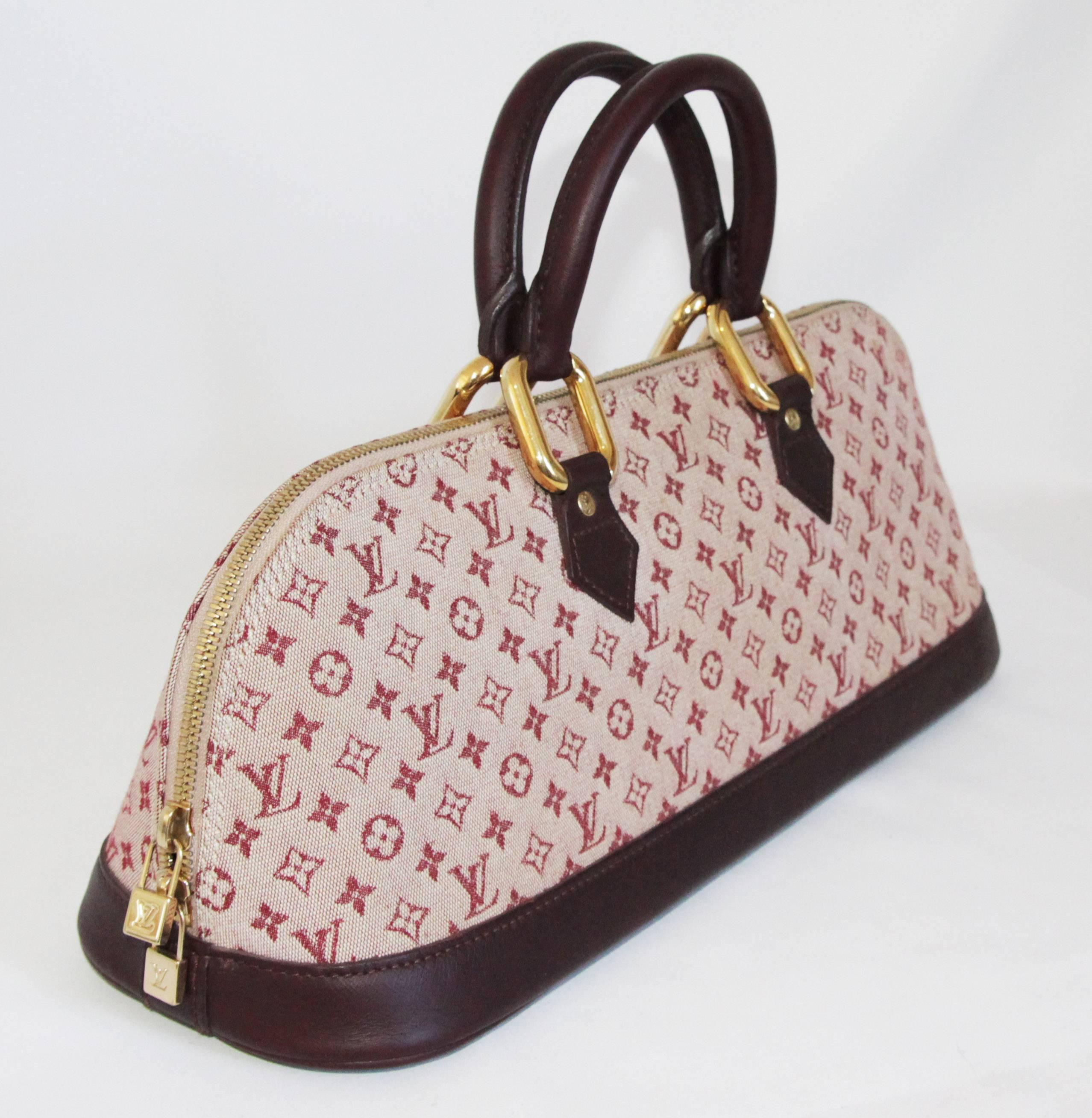 Gorgeous Louis Vuitton mini Alma long special edition handbag. Made of monogram fabric and burgundy leather. 

Created in 1992, the Original Alma model has been, for more than 20 years, one of Louis Vuitton’s most emblematic bags, on first-name