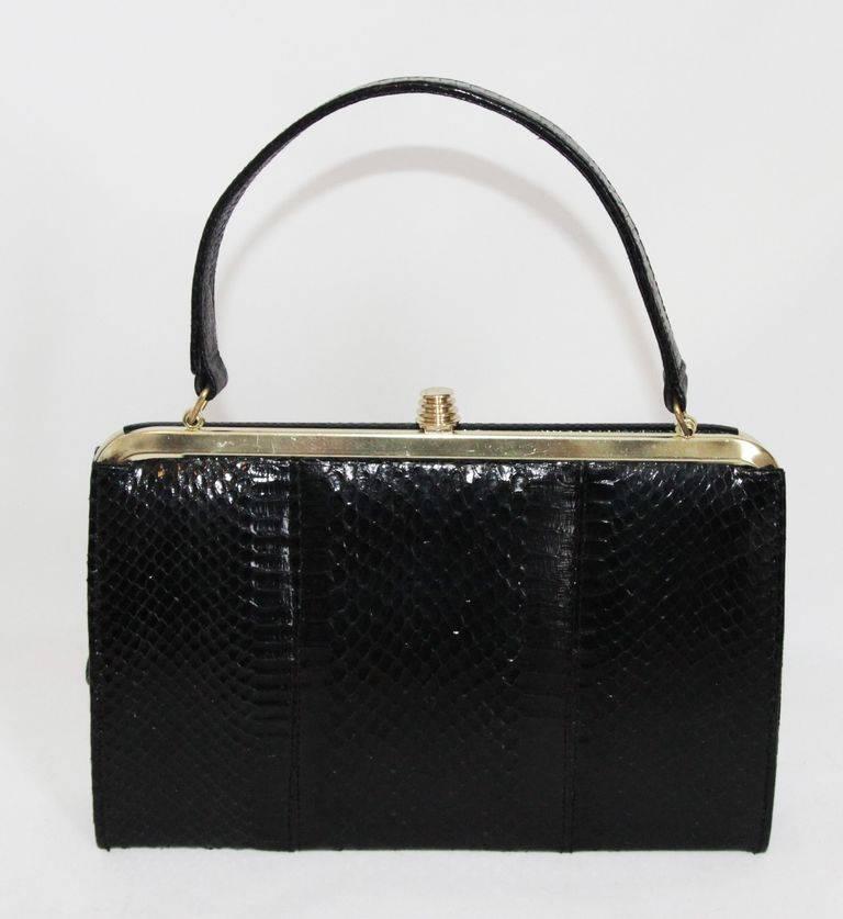 Stylish and very unique vintage snake & python handbag of the 60s. Black leather lining. Gold hardware. 

Size : 24 x 17 x 5 cm - 9.4 x 6.7 x 2 in.

Excellent vintage condition. 