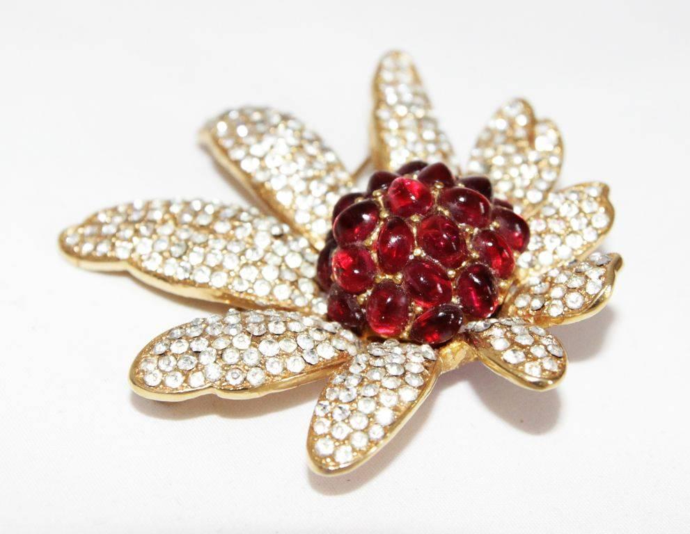A fabulous three-dimensional flower brooch made of crystal stones and deep red glass cabochons, signed Carven. c.1960 

Marked : Carven Modèle déposé

Size : 6.5 x 6.5 cm - 2.6 x 2.6 in.

Excellent condition.