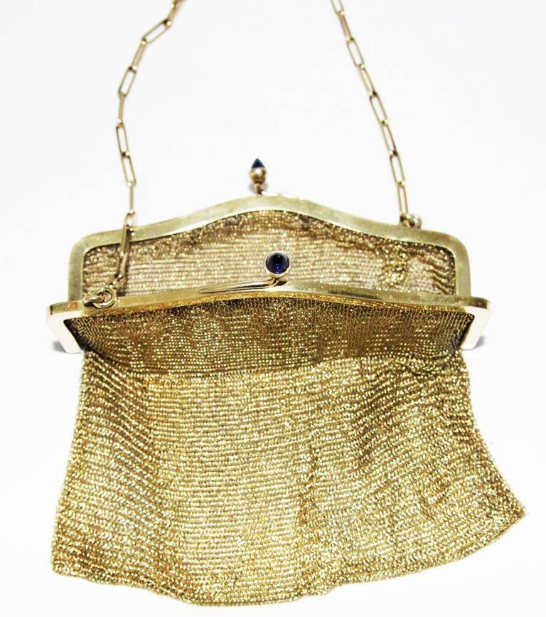 So elegant & rare to find.  Gilt mesh evening little bag of the 30s. Blue sapphire glass cabochons. 

Marked: 