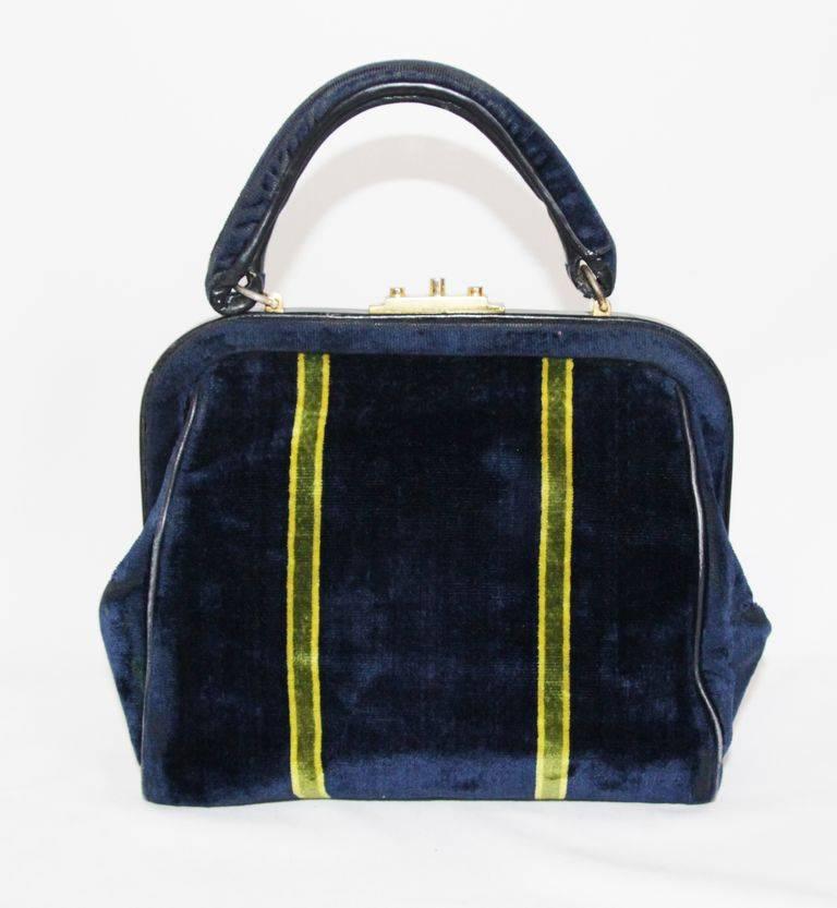 Very unusual and beautiful style for this collectable Roberta Di Camerino vintage little doctor bag.  Made of navy blue, green and yellow suede, leather lining and gilt metal hardware. 

Marked : Made in Italy by Roberto Di Camerino

Size : 22 x