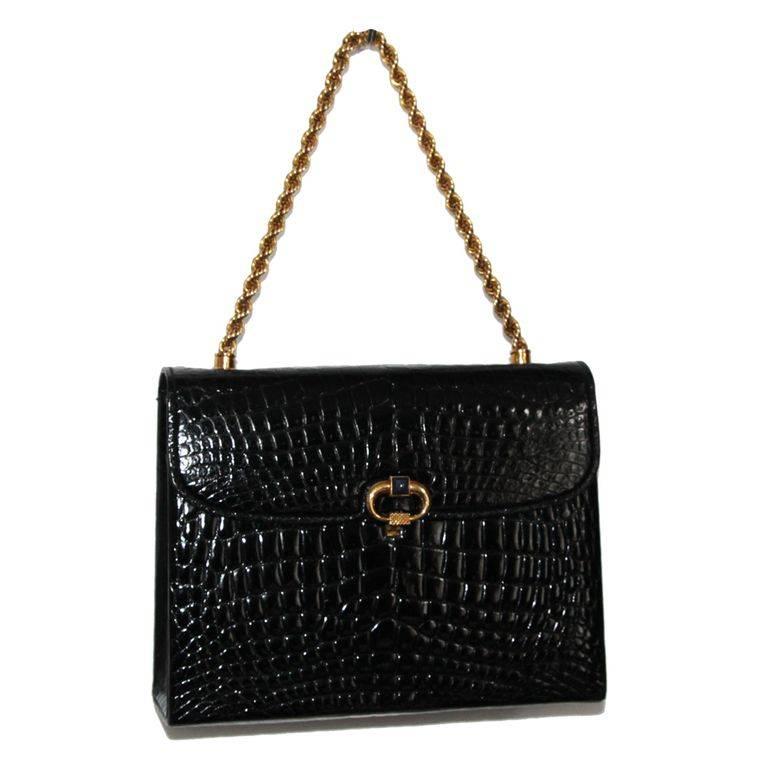 Gucci Rarity, fabulous and in excellent condition. c.1960. Made of black croco, gilt metal finishing and lapis-lazuli. 

Marked : Gucci

Size : 20.5 x 16 x 6.5 cm - 8 x 6.3 x 2.6 in. 

Excellent condition. 