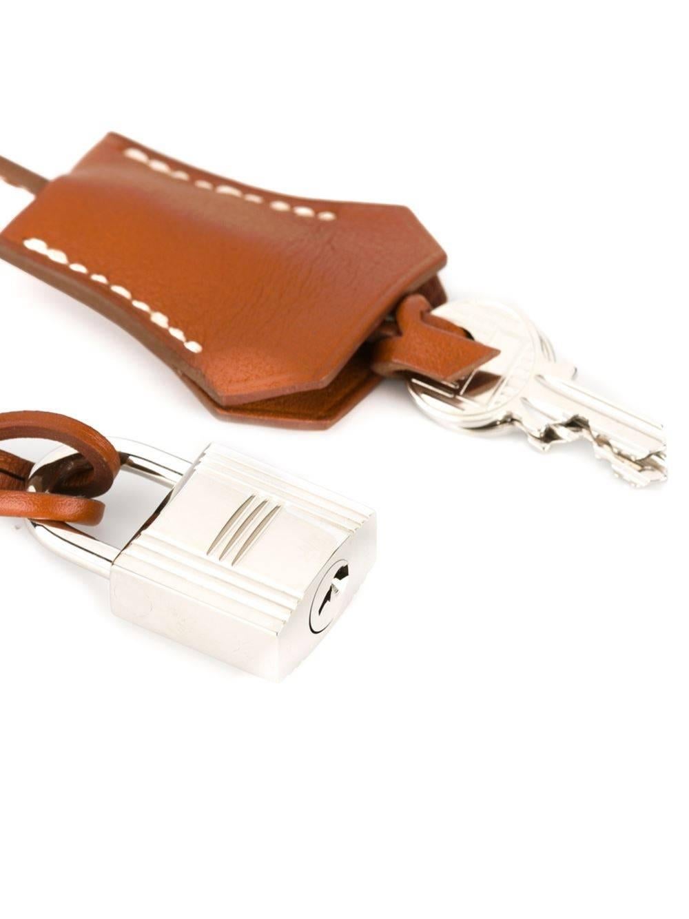 Hermès Vintage brown calf leather tag padlock featuring a silver-tone padlock and key. 

Size : Width: 3.8 cm, Length: 26 cm

Excellent condition. 