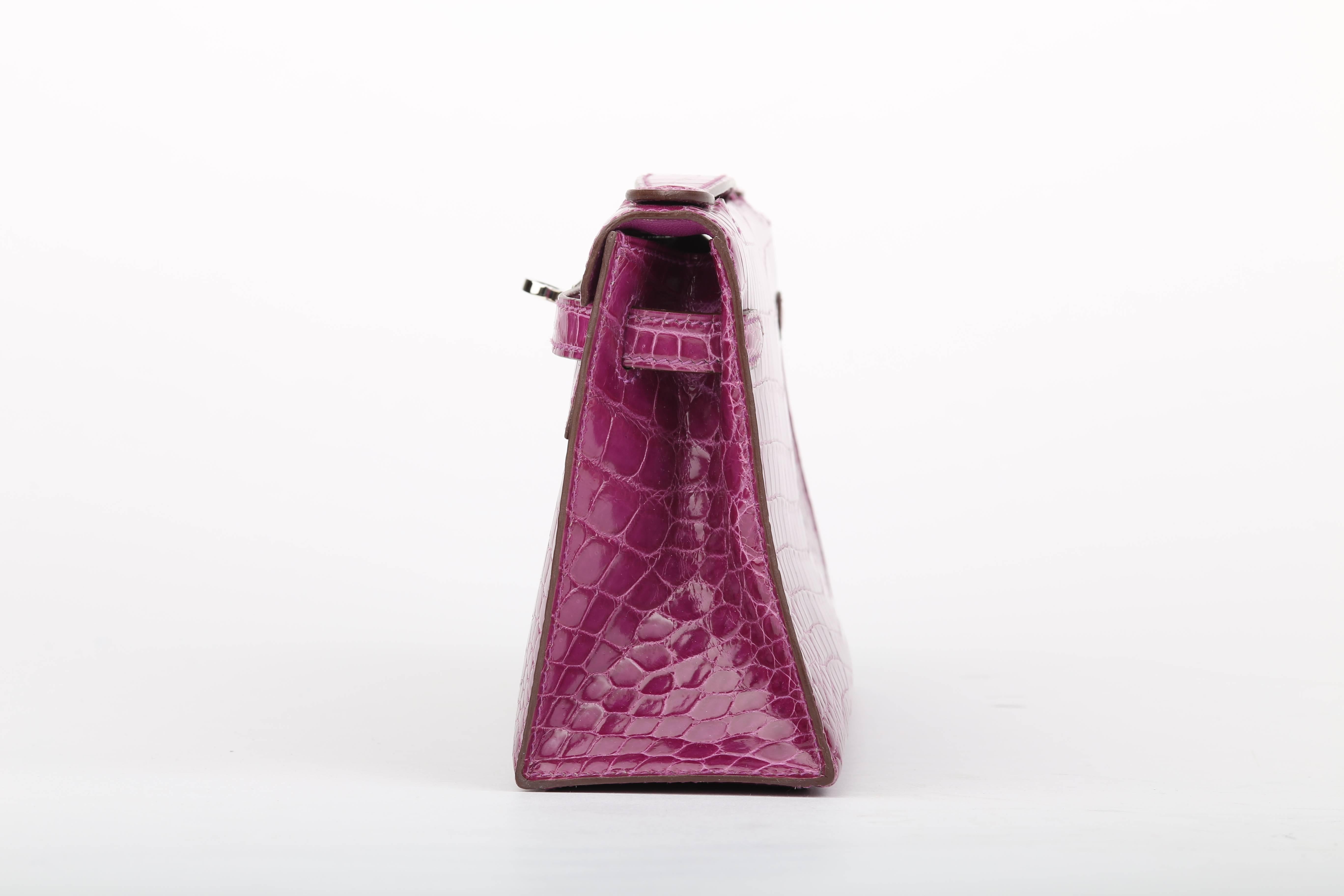 Hermes Kelly Pochette, made from  crocodile leather in Violet Color and Shiny Exotic Leather! 
 Features a single flat top handle, a branded palladium twist-lock hardware, protective palladium metal feet, and a leather lined interior with one patch