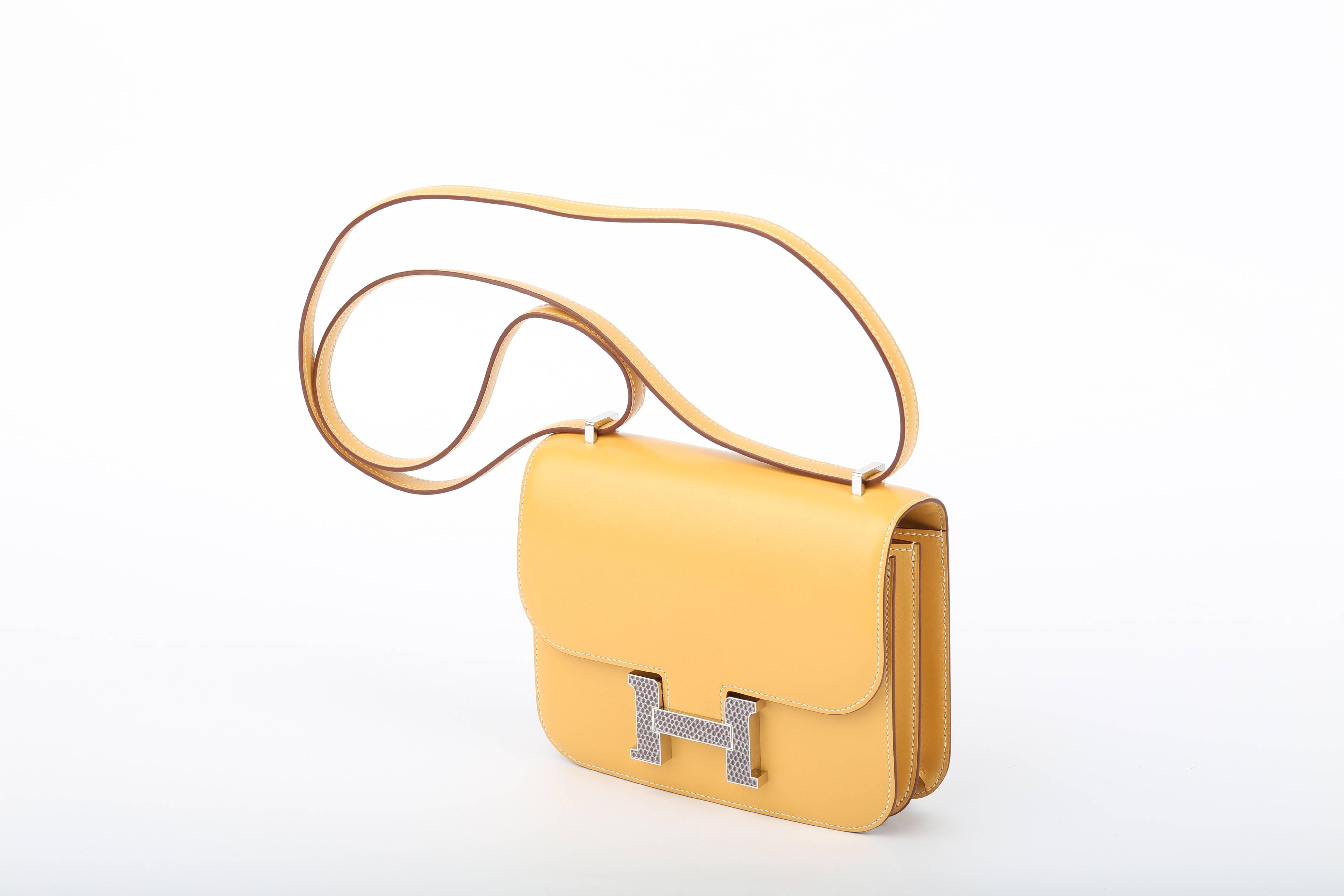 Hermes Constance Mini/ 18 cm  is one of the most appreciated collector’s items on the market.

This  Hermes Constance is a limited edition bag with white stitching and a buckle made from lizard skin in palladium hardware! 

One of a kind!