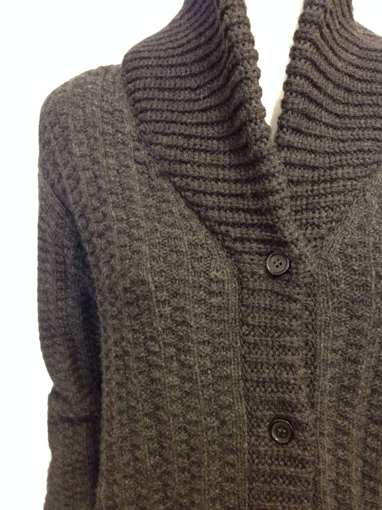 This must be the fanciest version of a vintage mens' cardigan! The cozy and chunky knit, the shawl collar v-neck and the two hip pockets looks chic and effortless when done by Prada. The rib knit is heavy and warm, and feels so comforting when