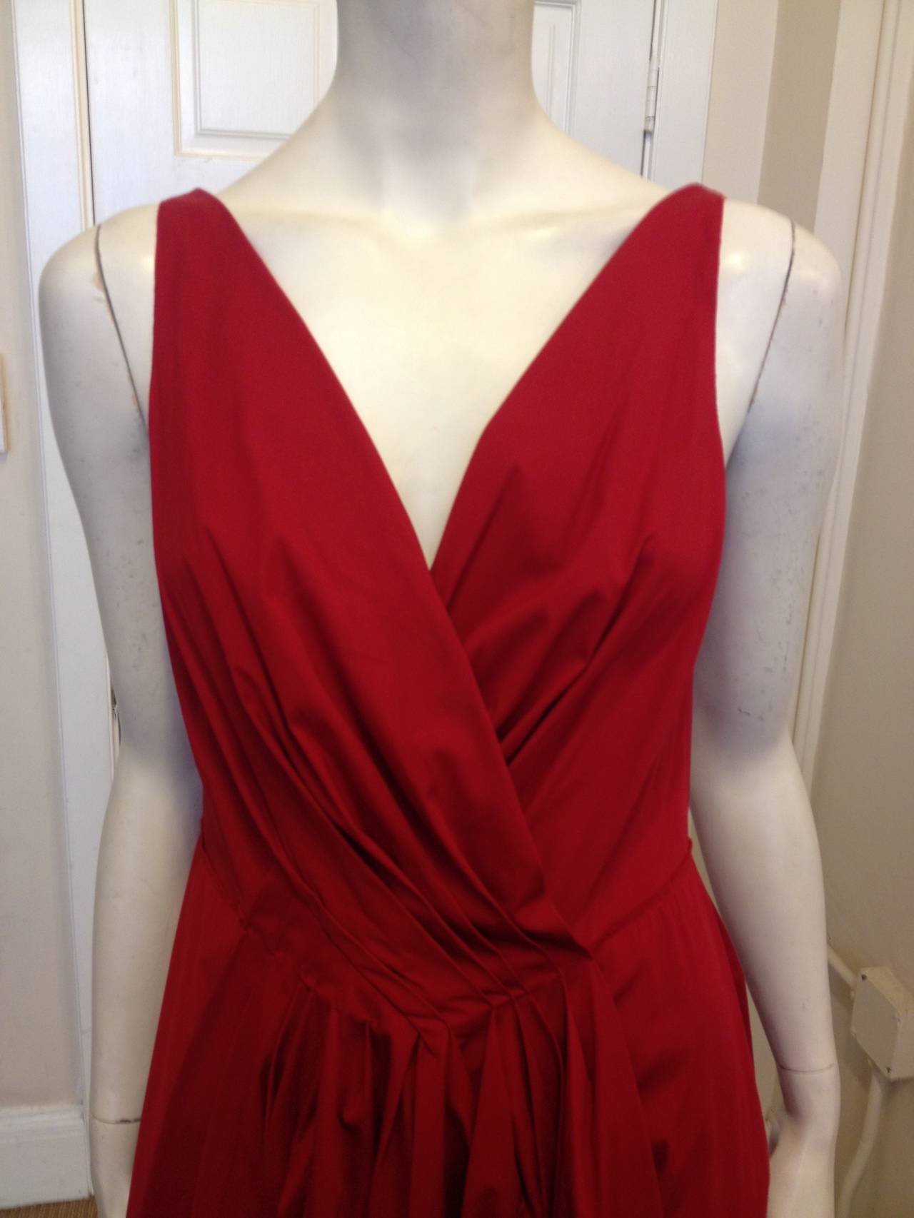 Nothing is more charming and eye catching than a bright red dress. The v-shaped neckline in the back complements the deep V in the front, which sweeps down into two angled sets of crossing pleats that create plenty of flare and movement. Four