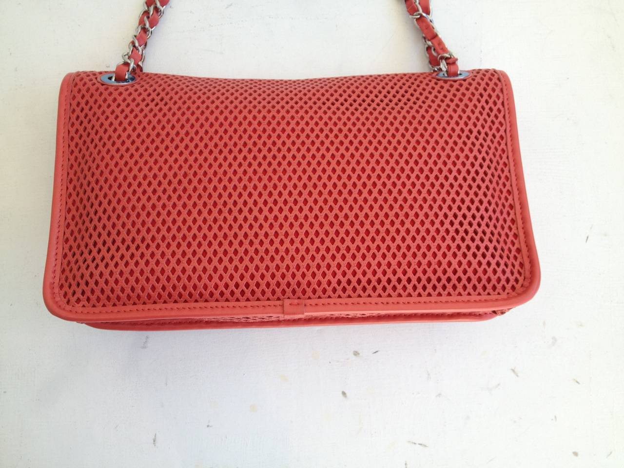 From the pre-Spring 2013 collection, the Up In The Air bag is at once fun, whimsical, and utterly fabulous. The piece departs from the usual quilted leather with its finely perforated coral red calfskin, while 2.55-inspired shape keeps the piece