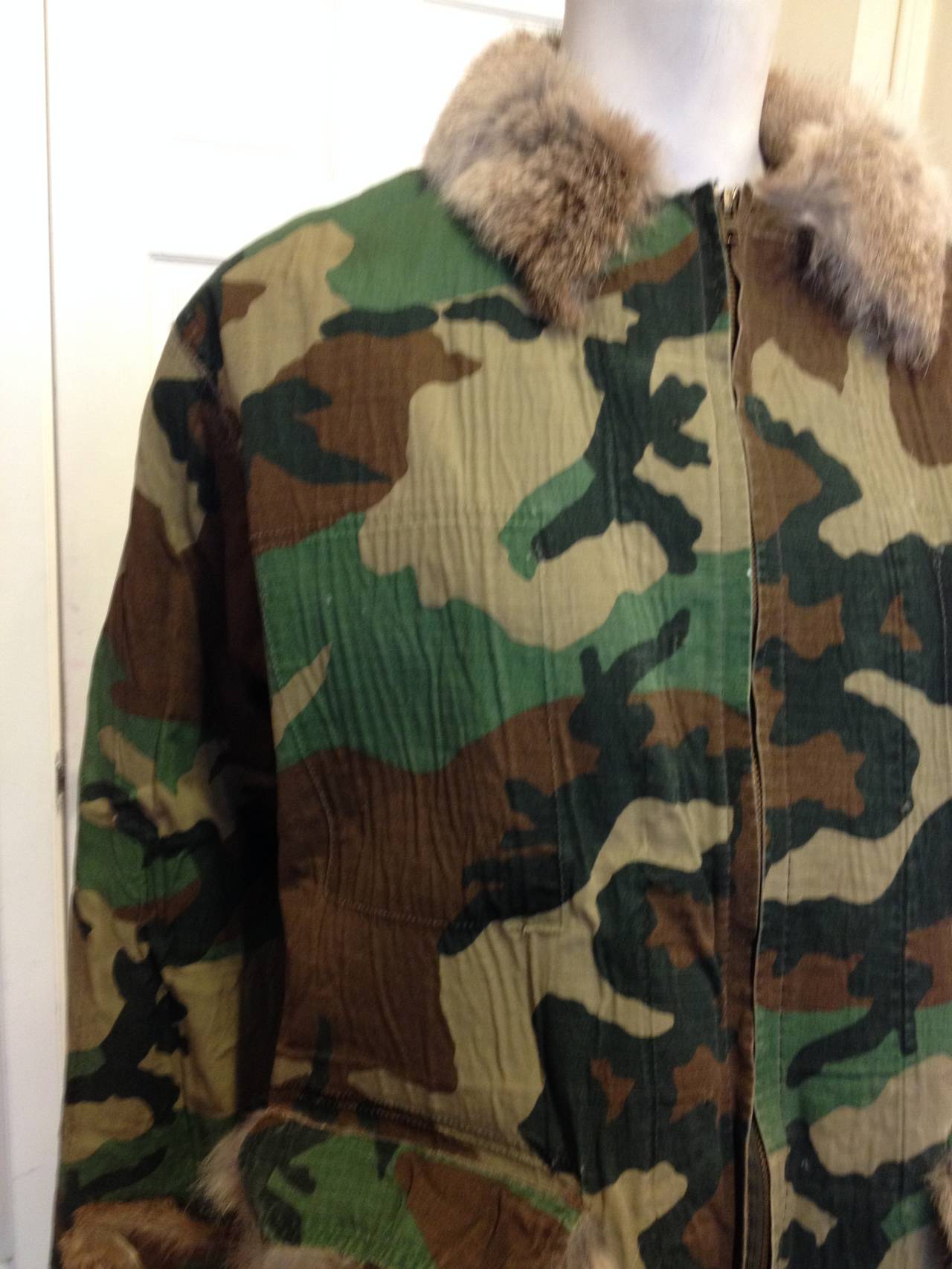 You won't blend in, even in camouflage - not in Jean Paul Gaultier! This jacket features an army-inspired print on the outside, while the inside is lined with an explosion of downy brown rabbit fur that peeks out at the collar, cuffs, and hem. The