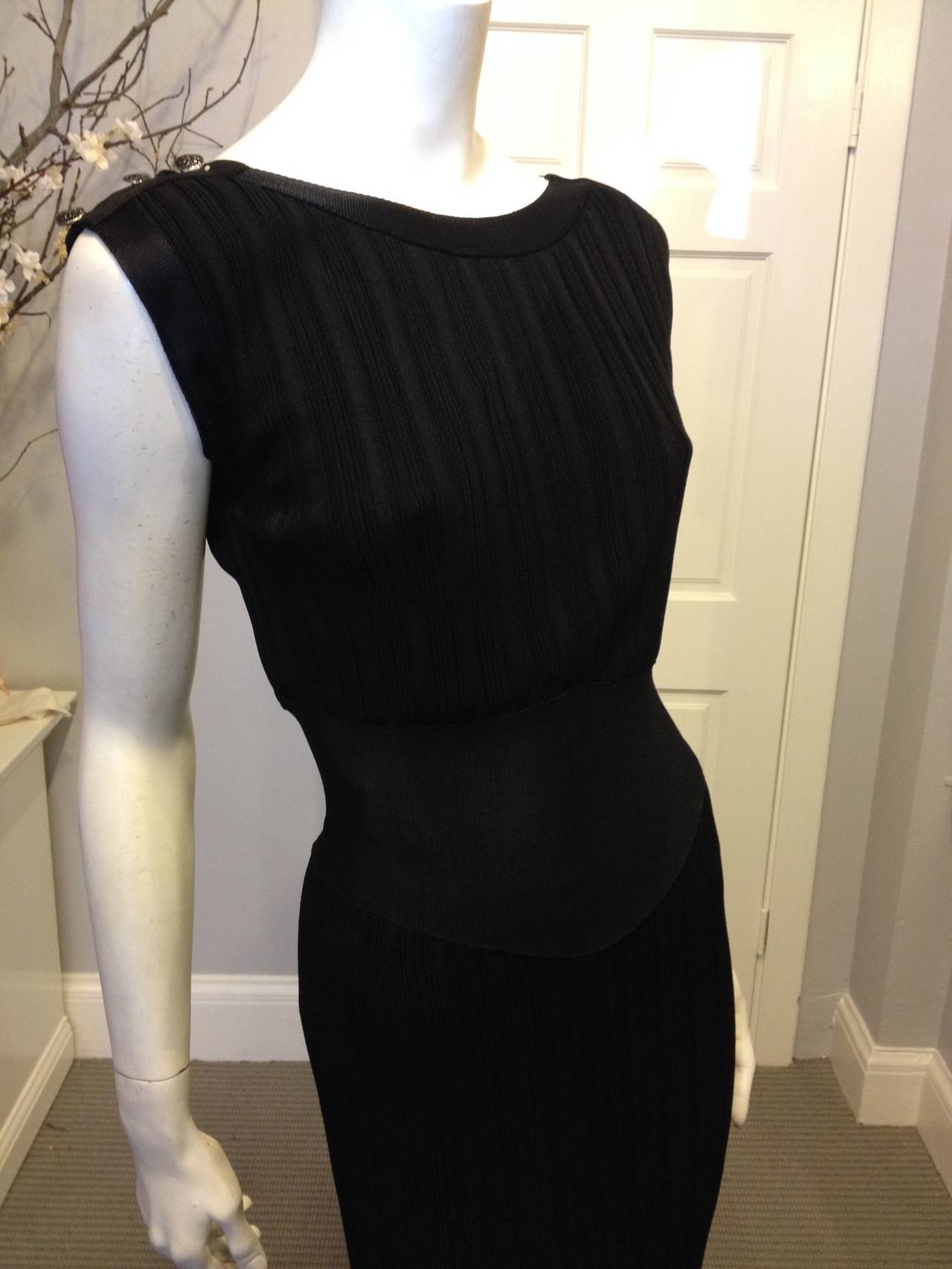 Evoke an old Hollywood starlet in this sweeping Chanel dress. Classically glamorous and always elegant, this piece features a wide boatneck front and a deep scoop back, falling into a gently loose top. The wide waistband, in a contrastingly flat