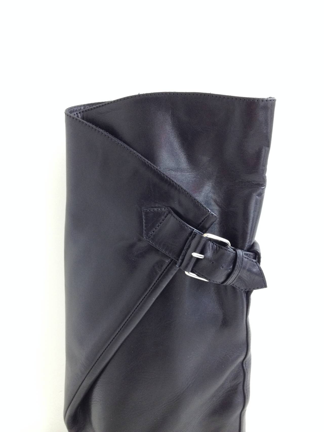 These boots are for the bold. With a striking architectural build, they are a composition of straight lines and sharp angles - the triangular 3.75 inch wedge, column shape of the boot shaft, and triangular buckled-down flap at the top. Balenciaga