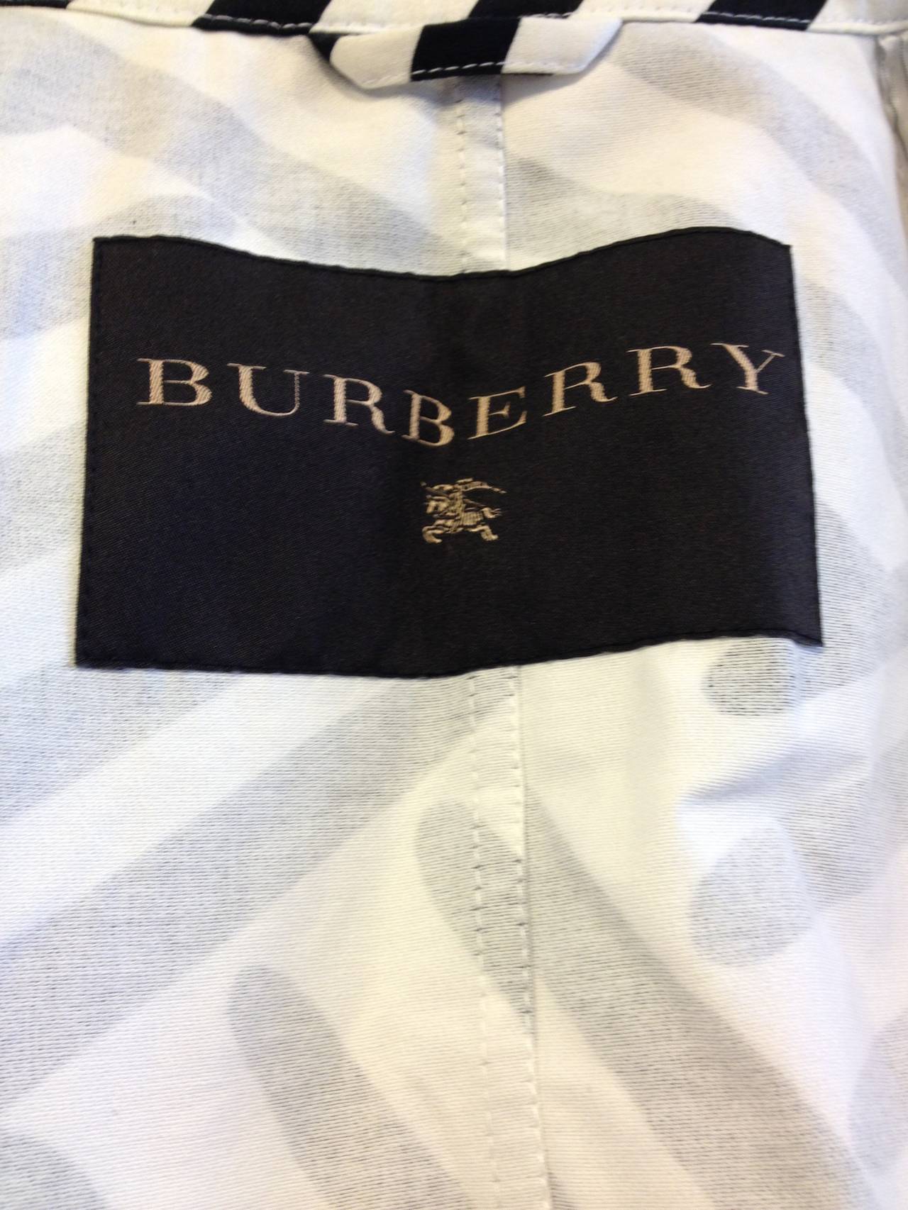 Burberry goes wild! This piece is rooted in the iconic trench coat, with the same collar and button-down flaps over the chest, but it becomes something fully new with its ultra graphic brushstroke print in bold black and white and its flared