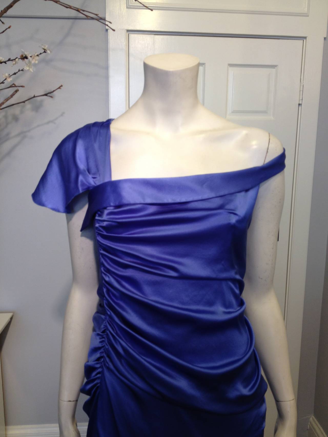 The brilliant blue of this Versace dress feels so perfect for a luxurious, hot Italian summer. Asymmetrical ruching and various ruffles make the satin ripple, adding just a touch of Grecian goddess draping. This dress would pair beautifully with