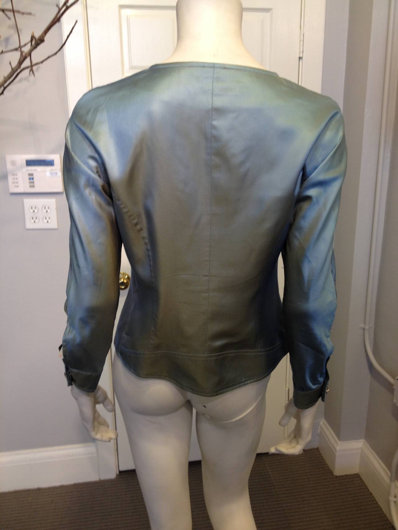 The perfect spring jacket! The fabric is a gorgeous iridescent that shifts from a soft ocean blue to warm yellowy gold when seen from different angles. The front is ruched for a flattering slim fit, with adjustable elastic cords letting you tailor