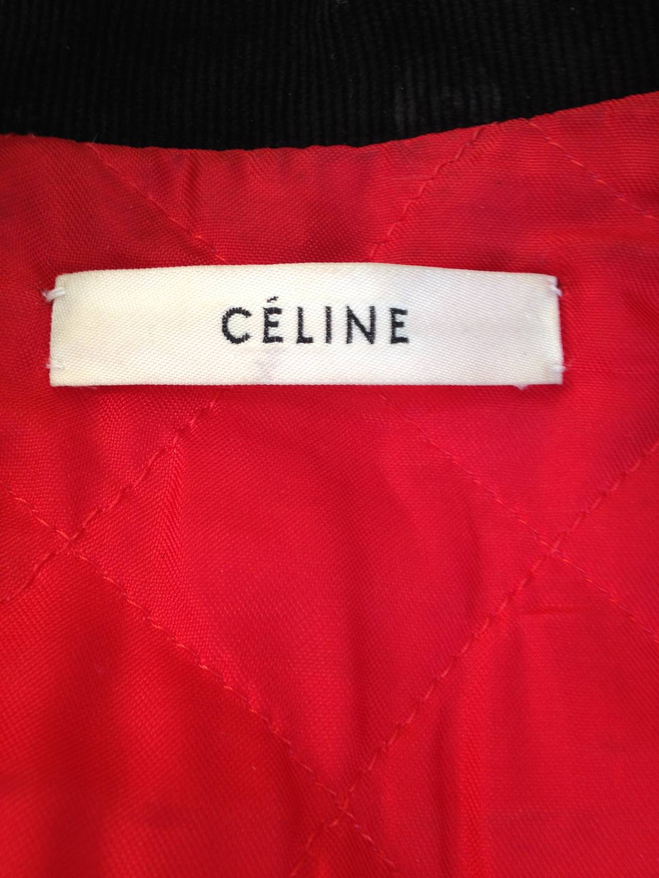 What a wild piece! This motorcycle vest by Celine, in an ultra soft leather, is decorated all over with a blossoming floral design. The sweetness of the soft whites and reds in the flowers contrasts the bold silver tone hardware and asymmetrical