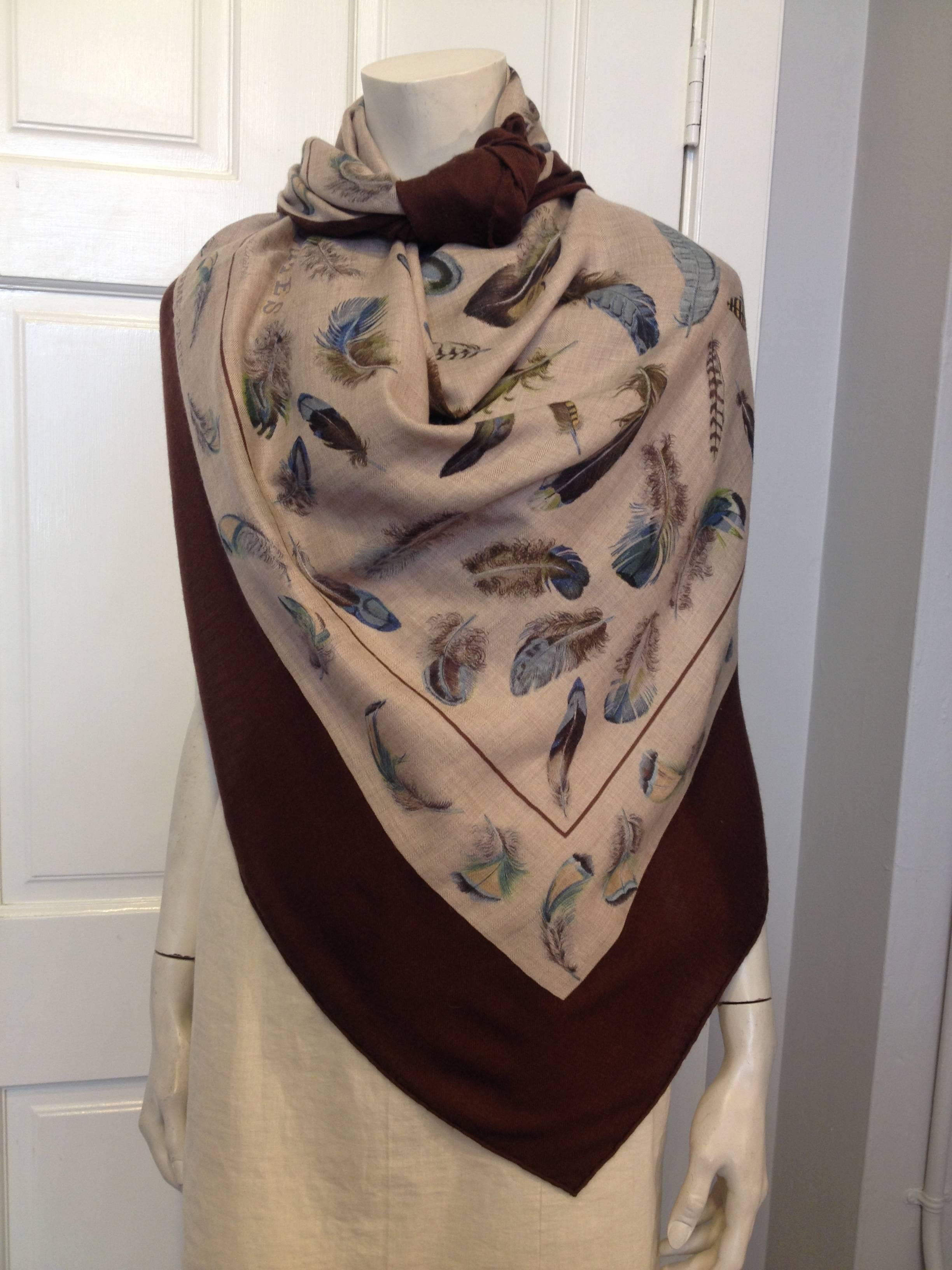 Brilliant blue and brown feathers in an array of tones float across this gorgeous Hermes shawl. Both neutral and not at the same time, it's perfect for adding a little warmth and style to any outfit. This scarf was designed by Henri de Linares, and