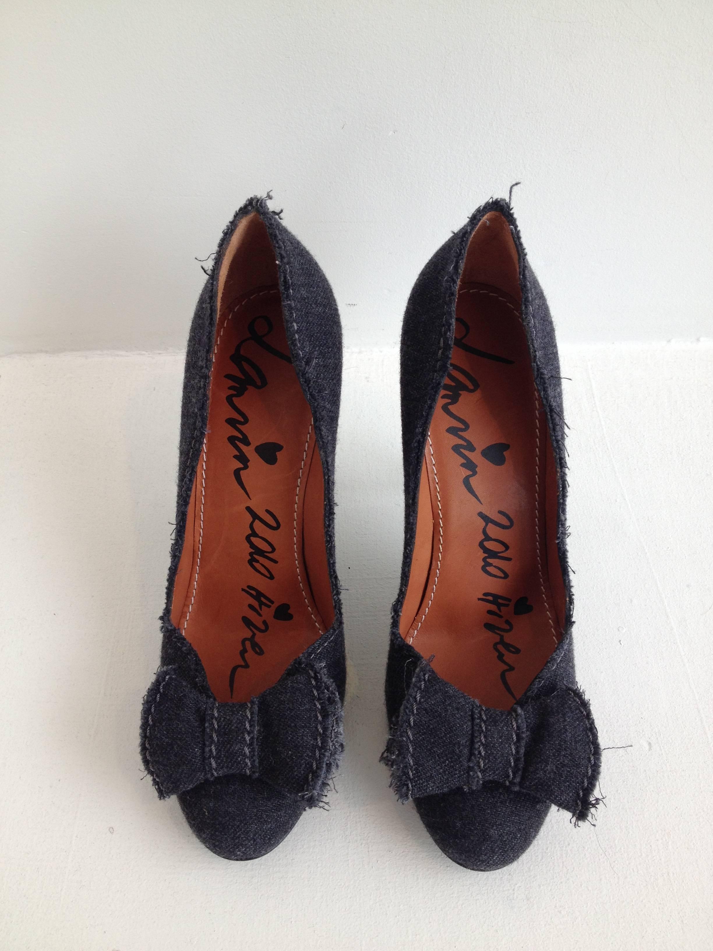 Feminine but edgy, these pumps by Lanvin are all you could ask for. The charcoal grey fabric is plush and wooly, adding a softness to the shoe, while the unfinished raw seams add attitude. The heel is three and three quarter inches high, while the