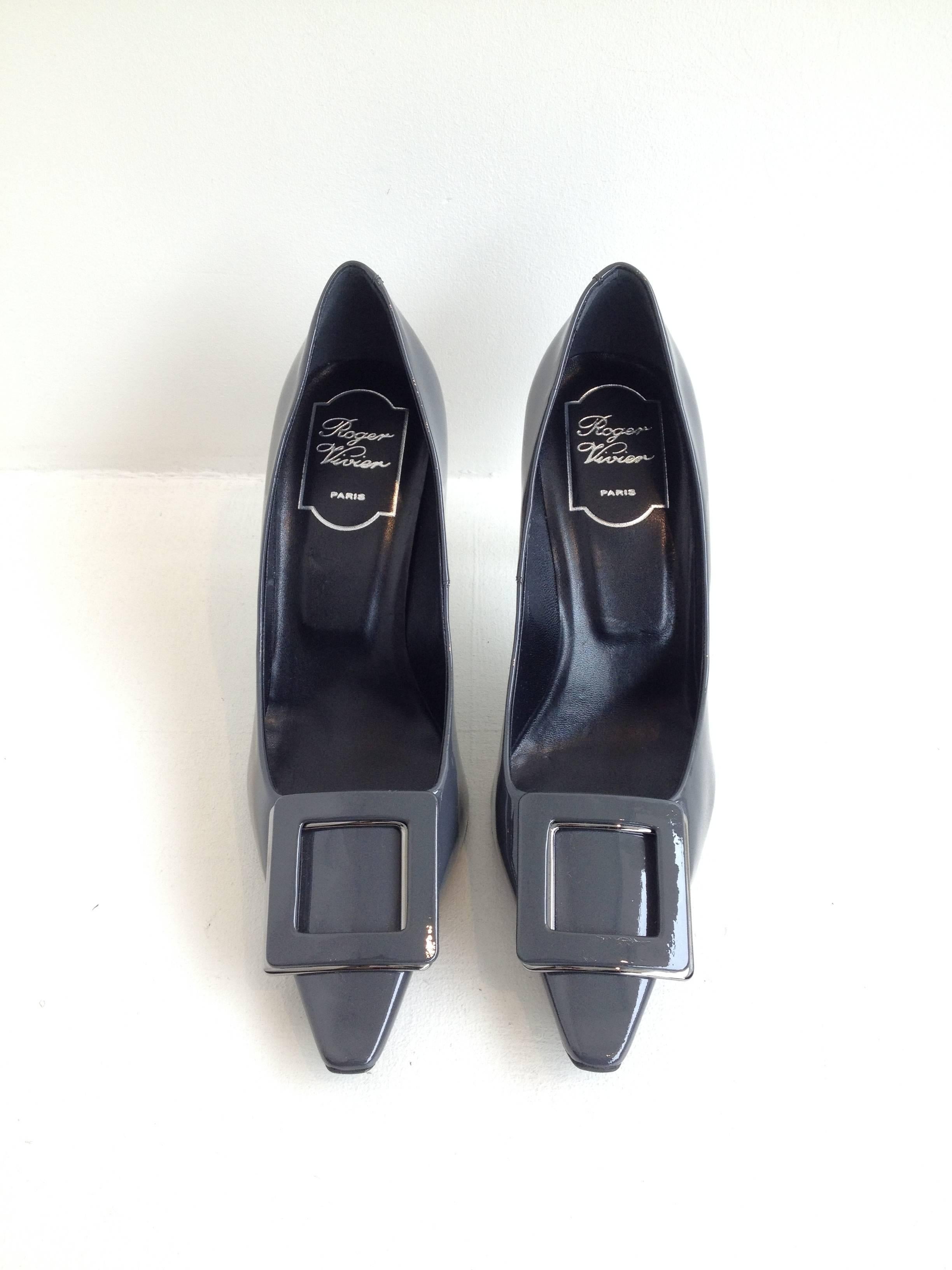 This classic Roger Vivier buckle always manages to feel current, thanks to the designer's constant updates to their shoes. This one is ultra pointy and has a gorgeous very slightly curved three inch heel. The dark steel grey patent is modern, while