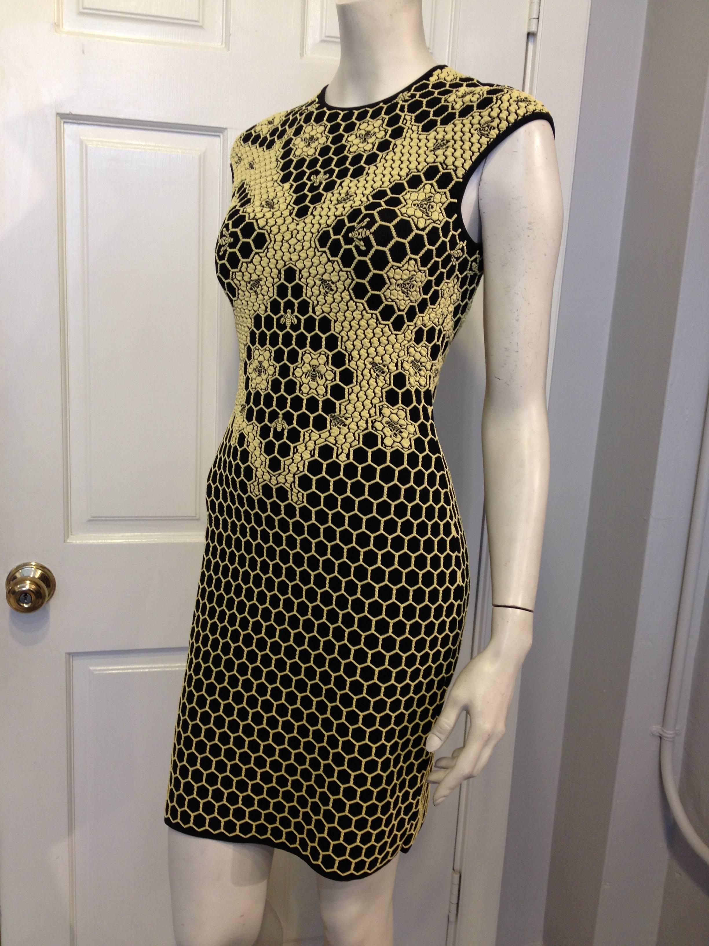 You'll be the best dressed in the hive in this Alexander McQueen piece. Yellow and black travel-friendly knit jacquard is cut into a snug bodycon fit, with a round neckline, cap sleeves, and a mini-length hemline. The material is woven with a