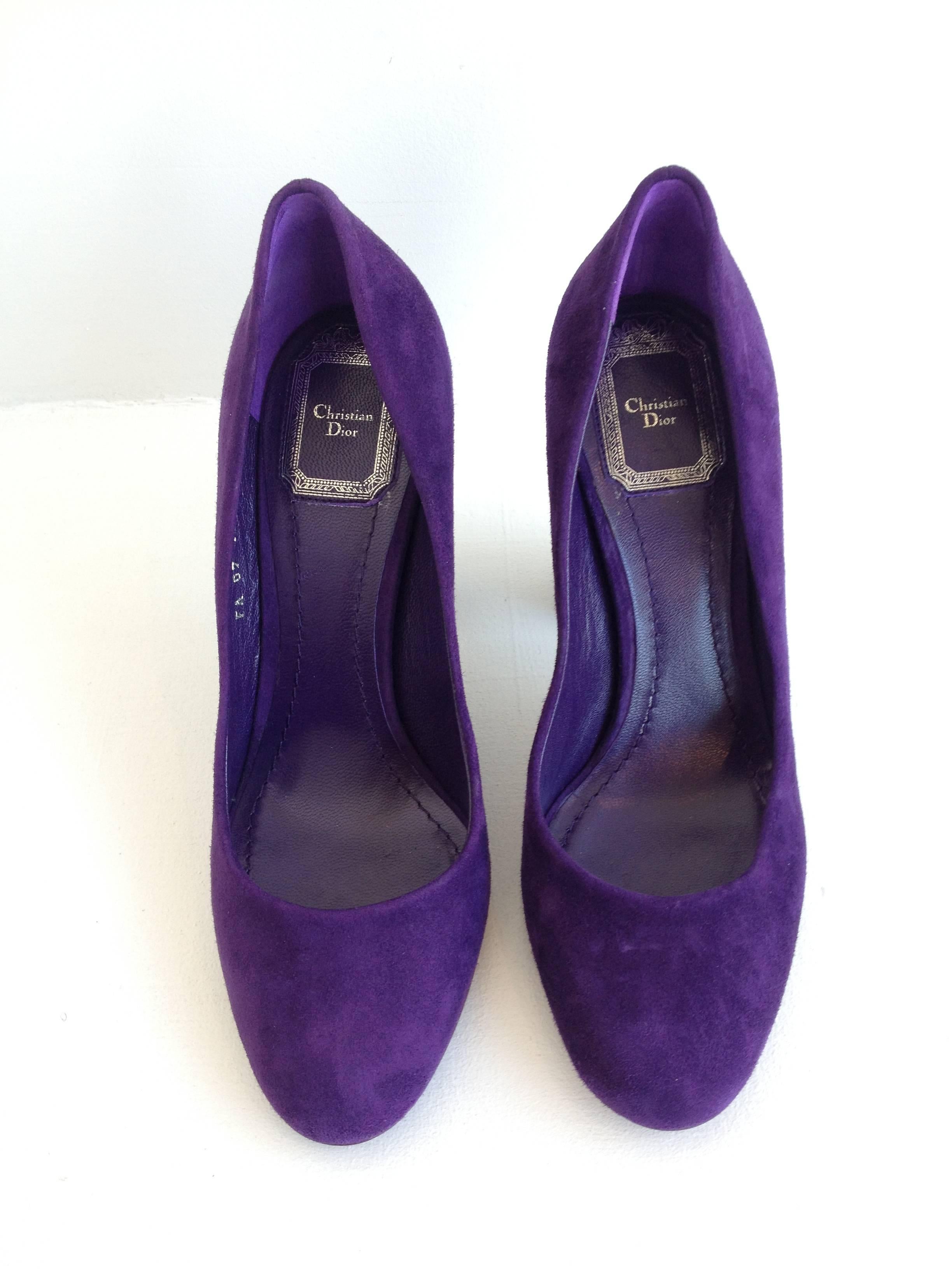 Graphic and bold, these pumps by Christian Dior have elements of the modern and of the classic. The bold cylindrical 4 inch heels are contemporary and fun, while the round toe is perfectly simple. Bright purple suede makes them really pop.