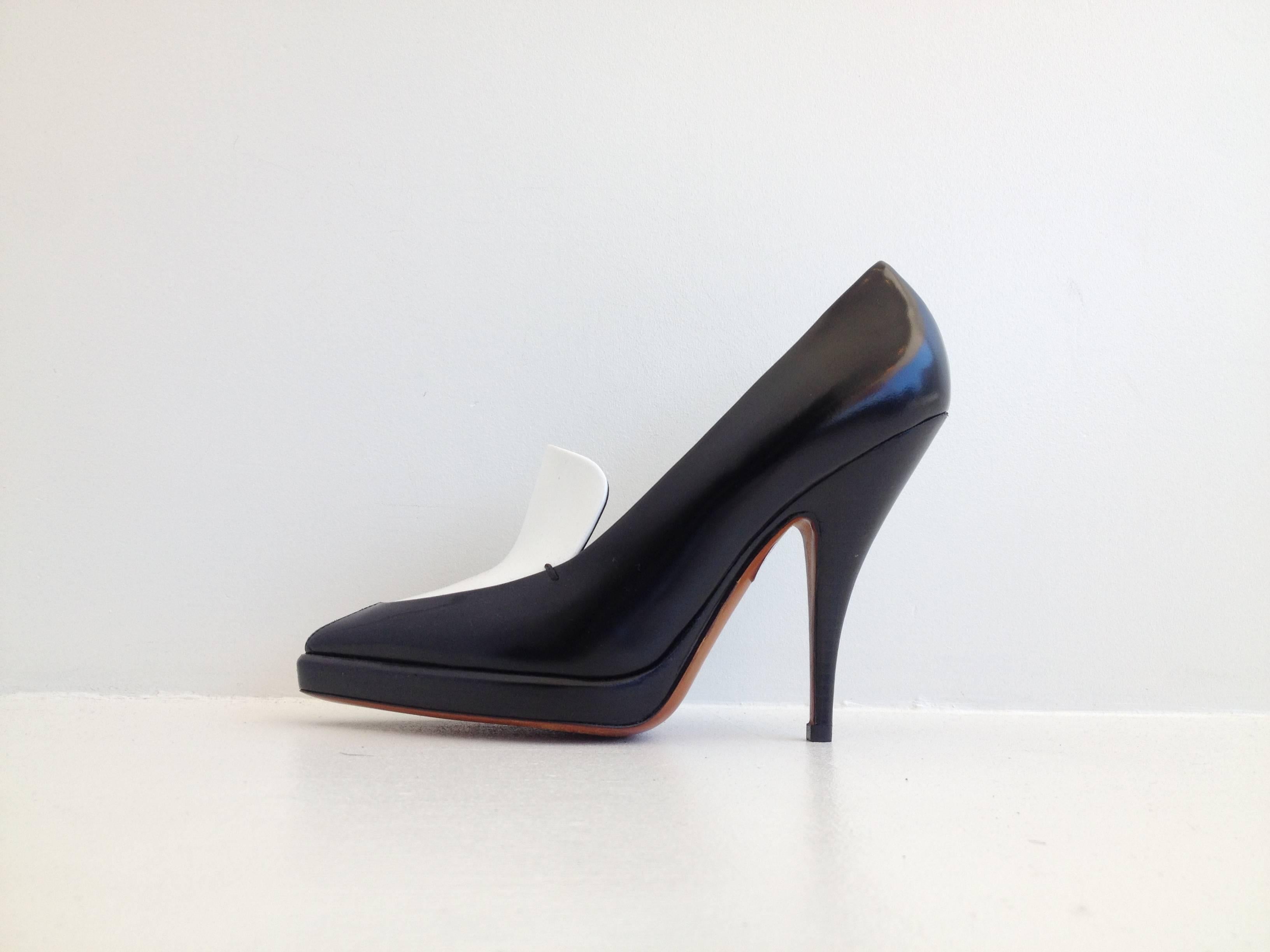 High contrast black and white makes a very bold shoe, and this pair by Celine is dramatic and sleek. The cut has both angles and curves, with the smooth white panel in the front coming to a point at the toe and a tapering 4.5 inch heel. The front
