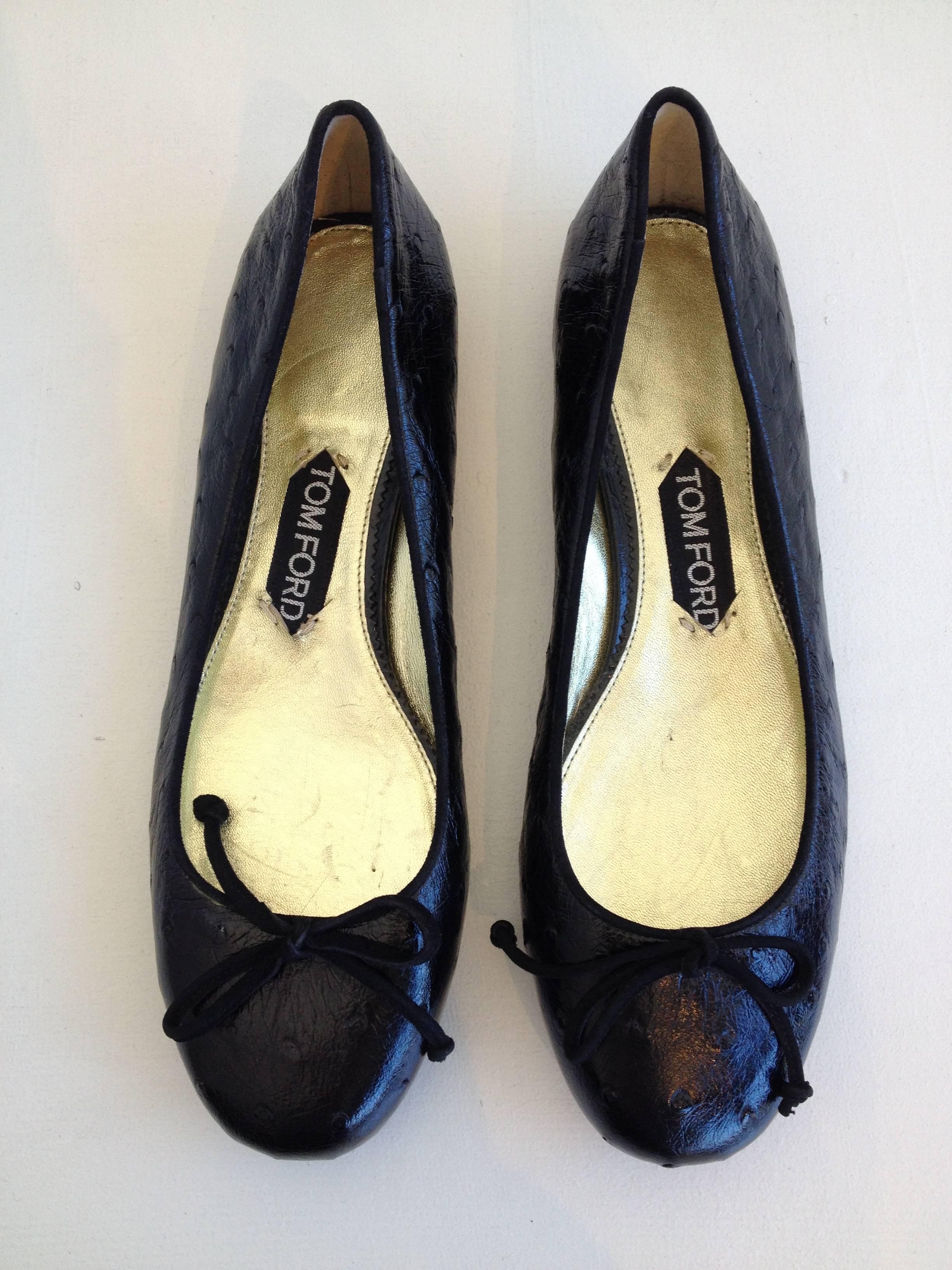 Beautiful ballet flats from Tom Ford. Black ostrich exterior with gold metallic lining. Quarter inch heel, classic ballerina cut.