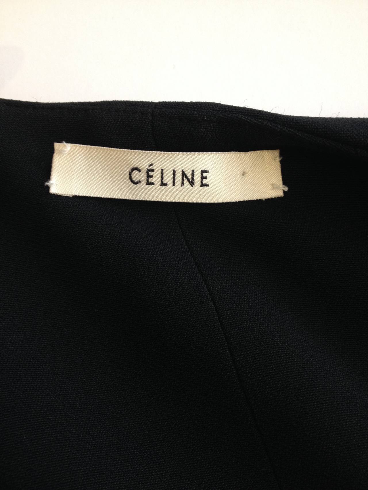 The precision and architecture of Celine pieces is always so striking. This vest is made of three straight and flat planes of fabric - the back and two front pieces, one of which folds over the other and snaps into place. The straight arm holes read