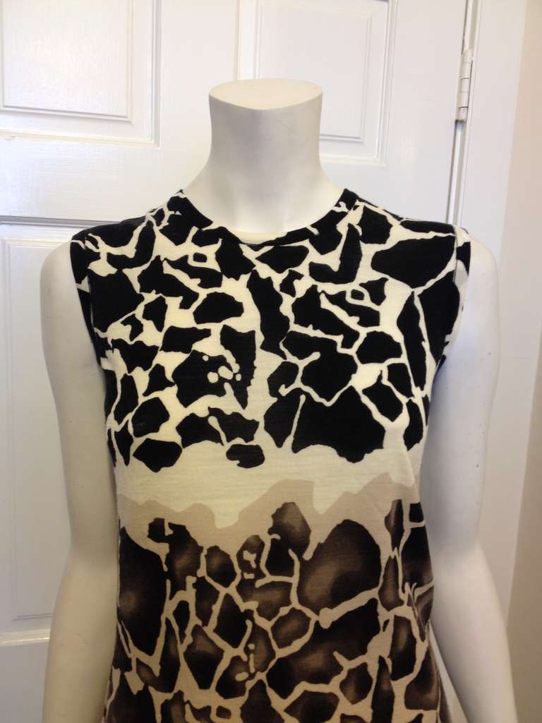 Queen of the jungle!  This fabulous knit top has an edgy animal print in great neutrals colors.  Wear this with basics to make a statement, it will look stunning with fitted black slacks or a full, pleated white skirt.  Wear it under a cardigan or