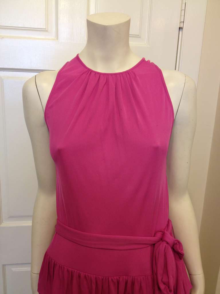 Fun, youthful, and feminine, this top is perfect whether you're going to a birthday or a dance, on a date or just out for ice cream. The rose pink color and high round neckline are sweet and pretty while the ruffles at the hem and the belted waist